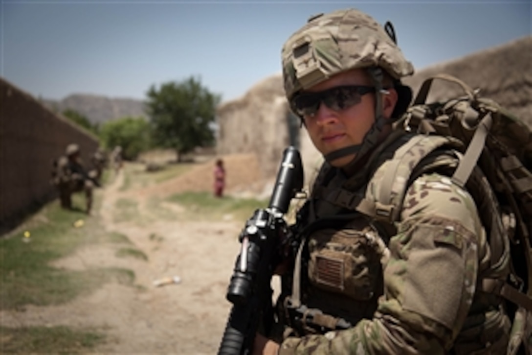 U.S. Army Spc. Josh Brimm with the 307th Psychological Operations Company stands guard along a dirt road near Malajat, in Kandahar province, Afghanistan, on June 3, 2011.  