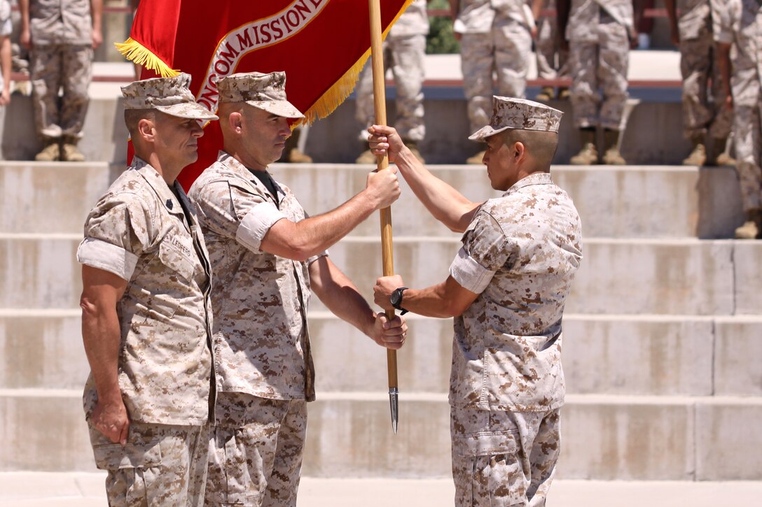 Master Gunnery Sgt. Javier S. Gonzalez, deputy director of the Camp Pendleton Staff Noncommissioned Officer Academy(right) , passes the colors to the newly appointed director of the base’s SNCO Academy, Sergeant Major Walter C. Baldwin as he relieves (left) Sergeant Major Robert A. Ledferd, June 14. Ledferd will be retiring as former director of the academy after serving 28 years in the Marine Corps. During the ceremony Ledferd was also awarded the Meritorious Service Medal for his accomplishments at the academy and throughout his career. The Staff NCO Academy’s mission is to provide sergeants and staff noncommissioned officers with the essential education and leadership training that will enhance their professional qualifications and prepare them to assume duties of greater responsibility, ultimately allowing for greater contributions to the Corps as leaders.