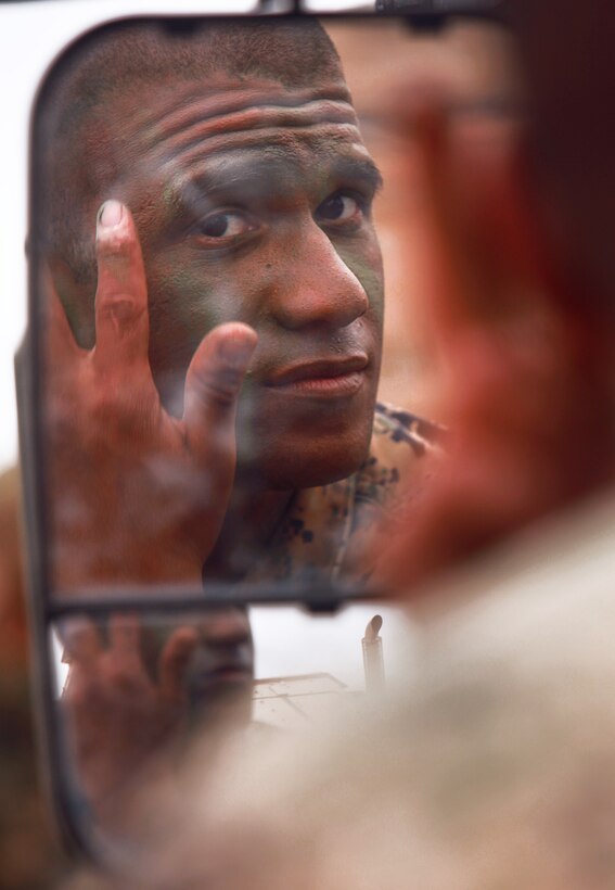 Reconnaissance Marine and Sugar Land, Texas, native Sgt. Alex Sanchez camouflages his face before a training mission here June 14. Sanchez serves with Battalion Landing Team 3/1, the ground combat element for the 11th Marine Expeditionary Unit, which is conducting its first large-scale exercise since becoming a complete Marine air-ground task force in May.