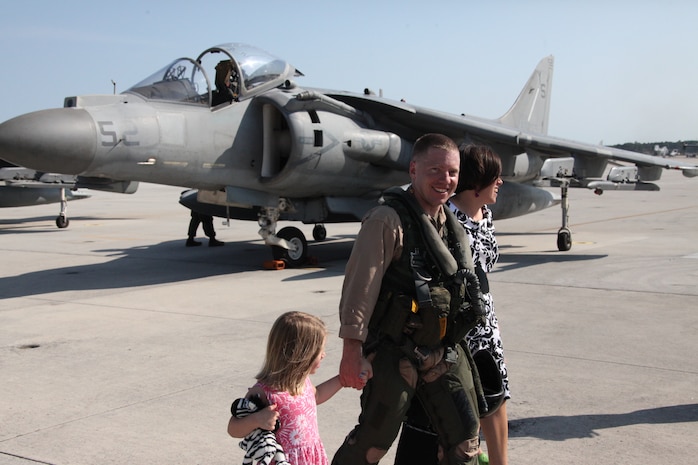 Capt. Jason Rubin, AV-8B Harrier pilot with Marine Attack Squadron 223, walks off the flight line at Cherry Point with his family.