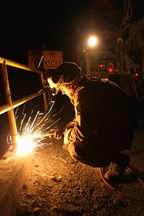 Cpl. Christopher L. Monson, from Blackfoot, Idaho, an automated maintenance technician with 7th Engineer Support Battalion, 2nd Marine Logistics Group (Forward), uses a gas torch to cut off the rails of a bridge in the Gamsir district, Helmand province, Afghanistan, June 16, 2011.  The Marines placed a bridge over the Darvishan Bridge as a temporary fix to allow Afghan contractors to repair it without stopping traffic in the area.  This project will directly benefit the Marines of 1st Battalion, 3rd Marine Regiment, 2nd Marine Division (Fwd.) who are currently operating in the district in support of the International Security Assistance Force as well as the local population.