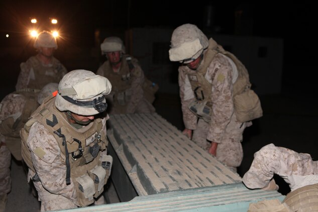 Marines with 7th Engineer Support Battalion, 2nd Marine Logistics Group (Forward) assemble a temporary bridge over the Darvishan Bridge in the Gamsir district, Helmand province, Afghanistan, June 16, 2011.  The Marines conducted the operation as a temporary fix to allow Afghan contractors to repair the structure without stopping traffic in the area.  This project will directly benefit the Marines of 1st Battalion, 3rd Marine Regiment, 2nd Marine Division (Fwd.) who are currently operating in the district in support of the International Security Assistance Force as well as the local population.