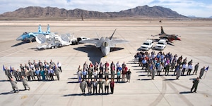 Members of the 98th Range Wing pose for a group photo on the Nellis flightline March 15. The 98 RANW was activated at Nellis Air Force Base Oct. 29, 2001 to operate, maintain and manage the NTTR complex. June 21, the 98 RANW legacy will live on at Nellis, but the name will change as the unit is re-designated as The Nevada Test and Training Range--a direct reporting unit to the U.S. Air Force Warfare Center. (U.S. Air Force photo by Airman 1st Class Jamie Nicley)