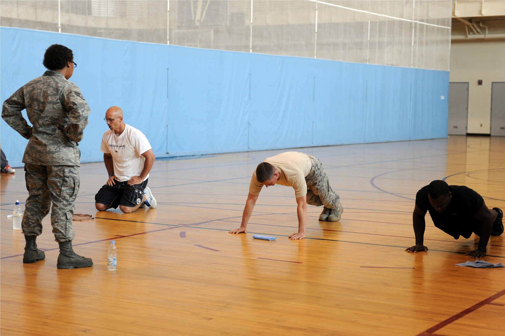 KUNSAN AIR BASE, Republic of Korea -- Staff Sgt. Katrina Mackson, 8th Communications Squadron commander support staff, watches as particpants complete push-ups during the First Sergeant’s Push-Up Challenge at the Fitness and Sports Center here June 15. Participants had an alloted time of 10 minutes to do as many Air Force style push-ups as possible. (U.S. Air Force photo/Senior Airman Ciara Wymbs)