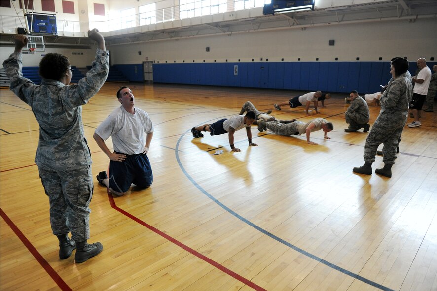 KUNSAN AIR BASE, Republic of Korea -- Staff Sgt. Katrina Mackson, 8th Communications Squadron commander support staff, cheers on participants in the First Sergeant’s Push-Up Challenge at the Fitness and Sports Center here June 15. Participants had an alloted time of 10 minutes to do as many Air Force style push-ups as possible. (U.S. Air Force photo/Senior Airman Ciara Wymbs)