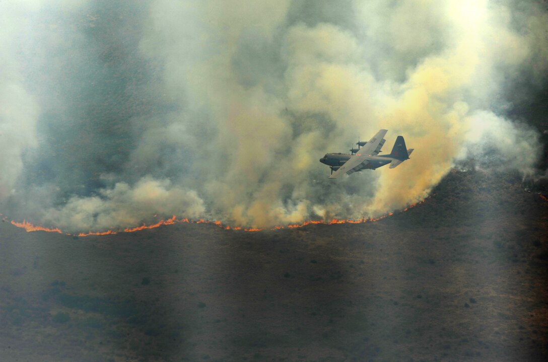 A C-130 Hercules from the Air Force Reserve Command's 302nd Airlift Wing in Colorado Springs,Colo., equipped with a Modular Airborne Firefighting System, drops a line of fire retardant in West Texas, April 27, 2011. MAFFS-equipped planes are capable of dispensing 3,000 gallons of water or fire retardant in under five seconds. MAFFs aircraft have been sent to New Mexico to support the ongoing firefighting efforts in the southwestern U.S. (U.S. Air Force photo/Staff Sgt. Eric Harris)