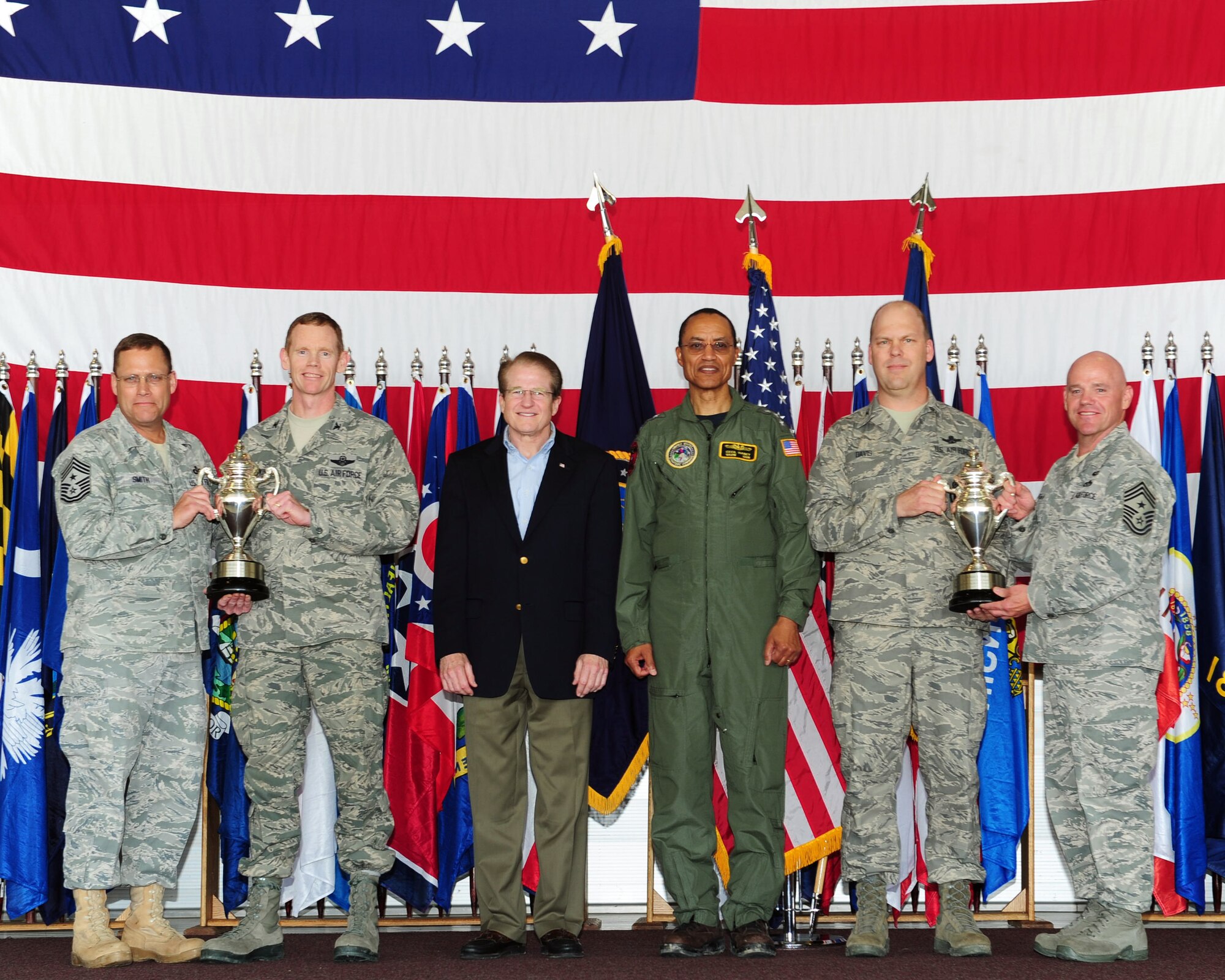 MINOT AIR FORCE BASE, N.D. -- Base leadership were presented Omaha Trophies by Mark Theisen, U.S. Strategic Command Consultation Committee representative, and Vice Adm. Cecil Haney, U.S. Strategic Command deputy commander, here June 15. The 5th Bomb Wing and the 91st Missile Wing received recognition for their hard work and dedication by receiving the Omaha Trophy for the Best Strategic Aircraft Operations and the Best Intercontinental Ballistic Missile respectively. The Omaha Trophy is awarded annually to military units demonstrating the highest performance standards in U.S. STRATCOM. (U.S. Air Force photo/Senior Airman Michael J. Veloz)