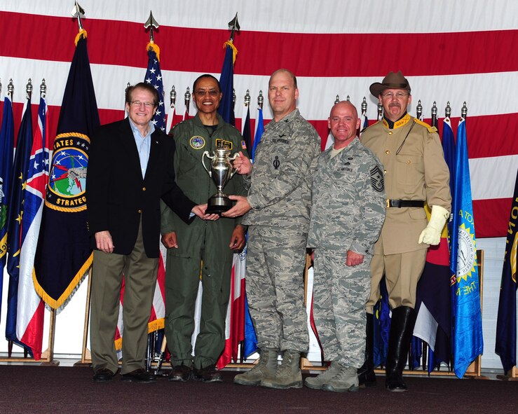 MINOT AIR FORCE BASE, N.D. -- Mark Theisen, U.S. STRATCOM Consultation Committee representative and Vice Adm. Cecil Haney, U.S. Strategic Command deputy commander, present the Omaha Trophy to Col. Stephen Davis, 91st Missile Wing commander and Chief Master Sgt. John Hoffman, 91st Missile Wing command chief here June 15. Team Minot received recognition for their hard work and dedication by receiving the Omaha Trophy for the best intercontinental ballistic missile and best strategic aircraft operations. The Omaha Trophy is awarded annually to military units demonstrating the highest performance standards in U.S. STRATCOM. (U.S. Air Force photo/Senior Airman Michael J. Veloz)