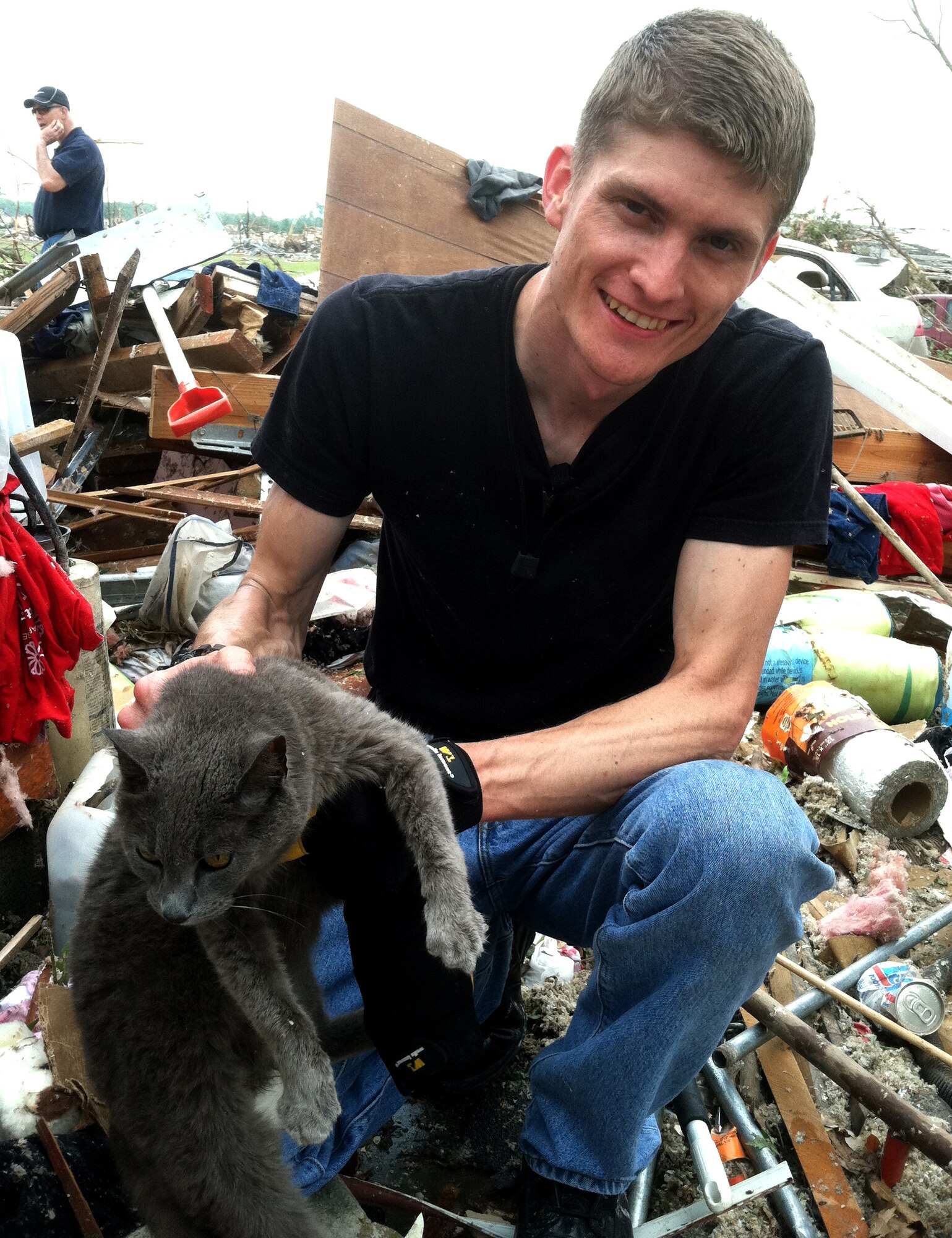 1st Lt. David Stuckenberg, a pilot in the 3rd Special Operations Squadron at Cannon Air Force Base, N.M., holds a cat found in the rubble, May 24, 2011. Lt. Stuckenberg facilitated a relief convoy to Joplin, Mo. as soon as he was notified that the May 22 tornado destroyed his hometown. (courtesy photo)(RELEASED)
