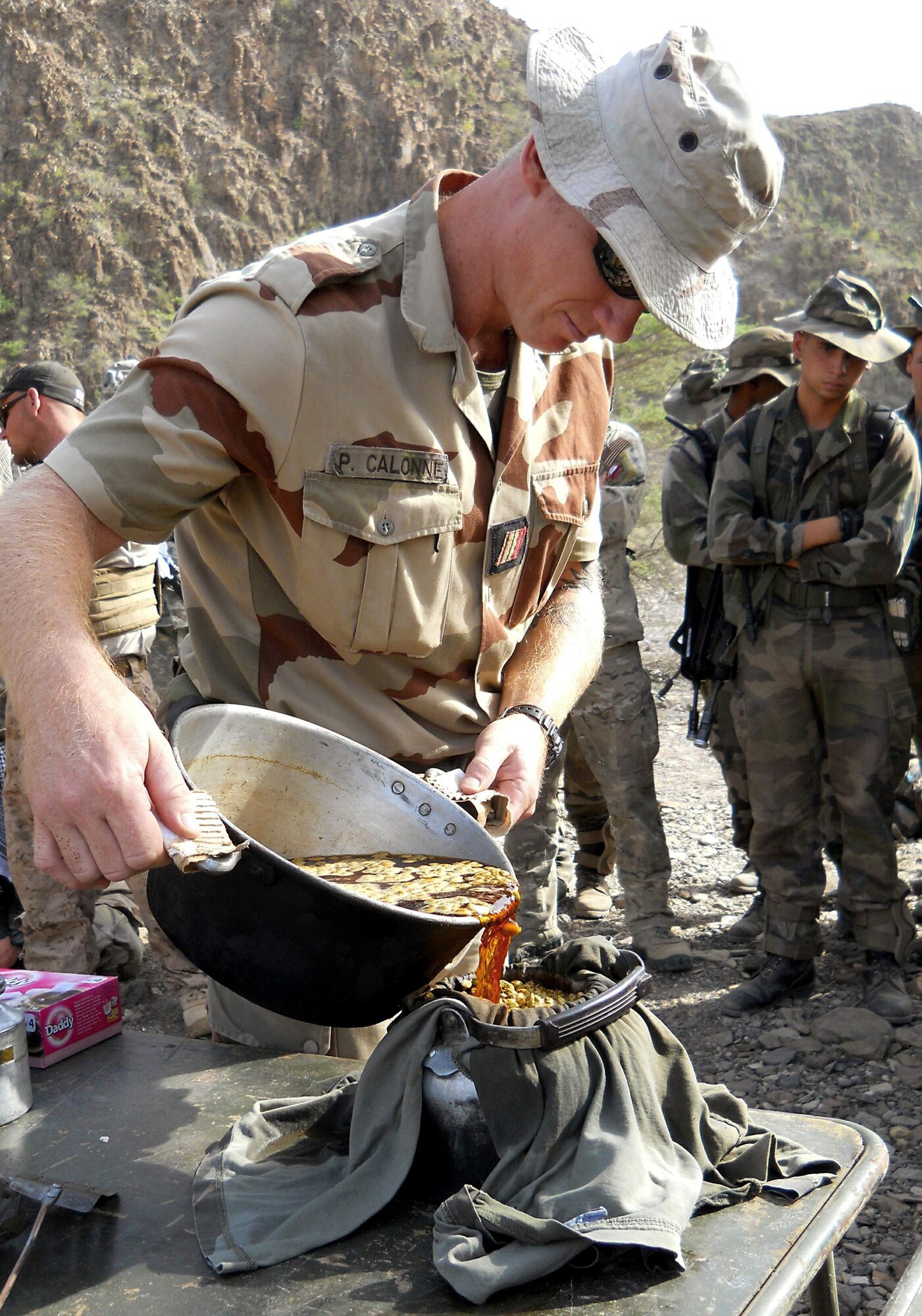 A desert combat training instructor with the 5th French Marine Regiment prepares a pot of tea during a desert combat training course which began May 31, 2011, in the Bour Ougoul training area in Djibouti. The 10-day course provided nearly 120 French and 40 U.S. service members with a basic knowledge of field tactics and survival techniques to use in a desert environment. (U.S. Air Force photo/Staff Sgt. R.J. Biermann) 
