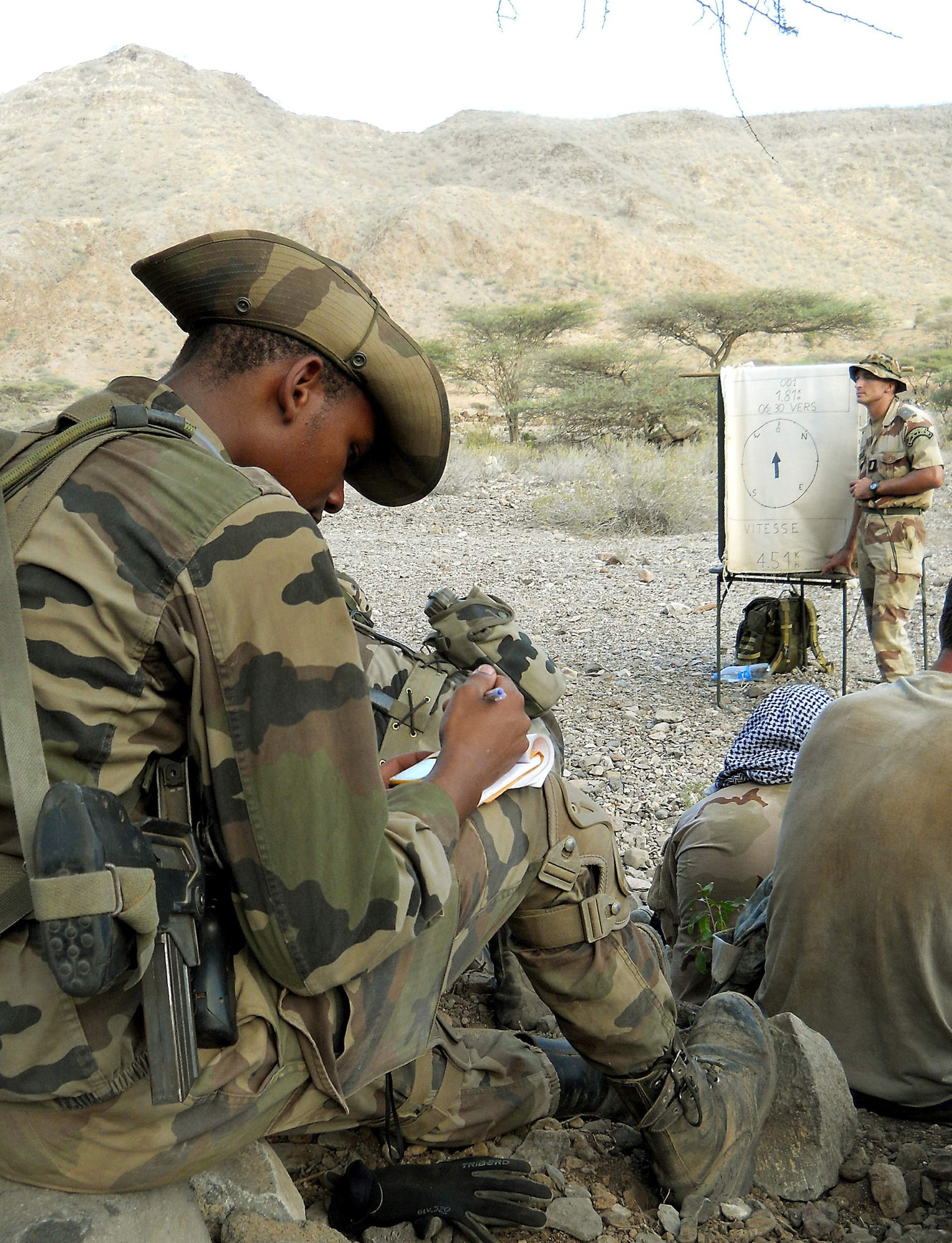 A member of the 5th French Marine Regiment takes notes on how to use a global positioning system device during a desert combat training course which began May 31, 2011, in the Bour Ougoul training area in Djibouti. The 10-day course provided nearly 120 French and 40 U.S. service members with a basic knowledge of field tactics and survival techniques to be used in a desert environment. (U.S. Air Force photo/Staff Sgt. R.J. Biermann)