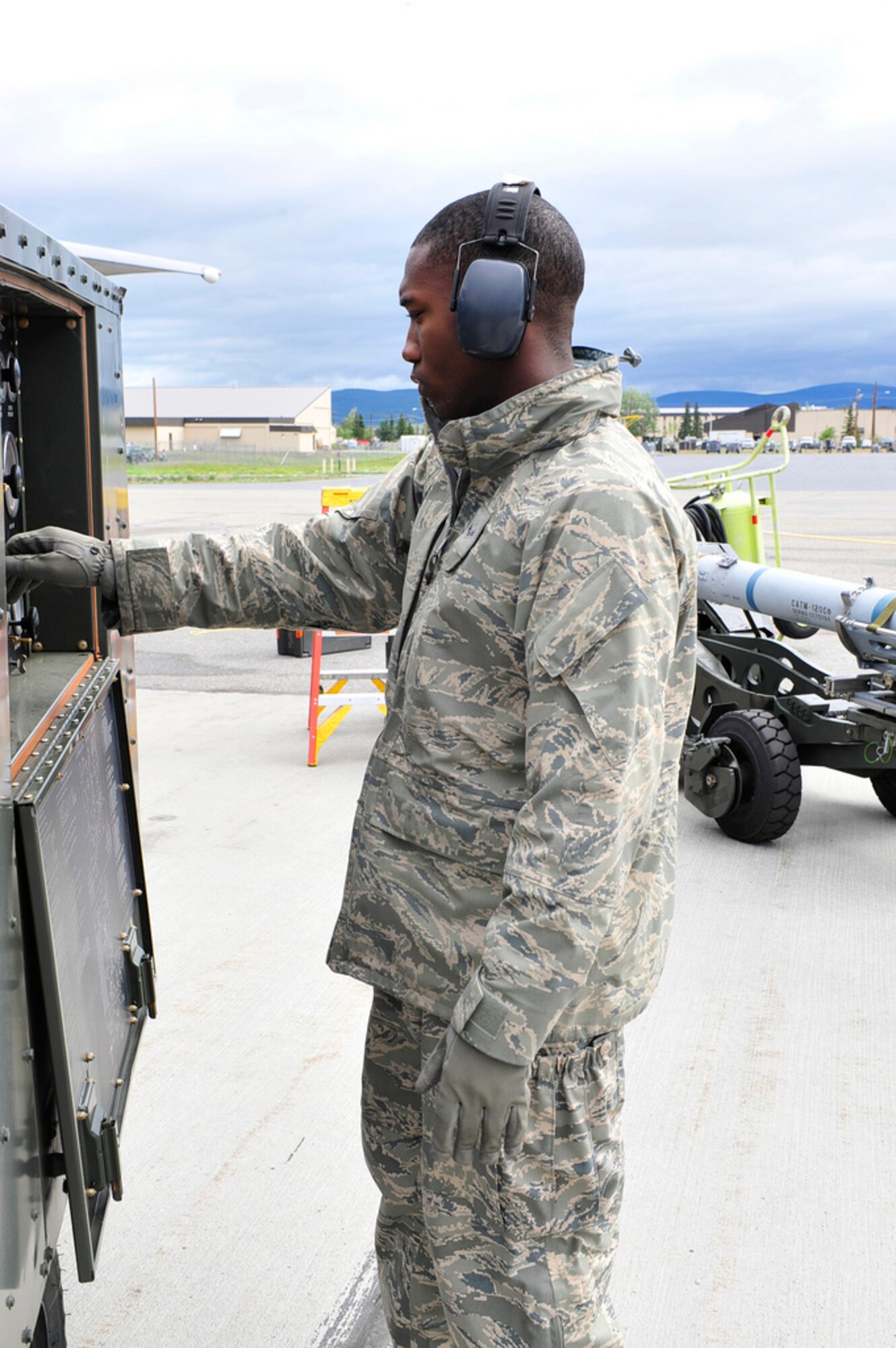 Airman 1st Class John Johnson III, an Aircraft Armament Journeyman with the 391st Aircraft Maintenance Unit, Mountain Home Air Force Base, Idaho, spins up a generator to complete an M-9 function check for an F-15 Eagle during the Northern Edge Exercise at Eielson Air Force Base, June 13.  This exercise is designed to help participants hone their skills in their area of expertise and increase command, control and communication efficiency. (U.S. Air Force photo/ Staff Sgt. Lakisha A. Croley)