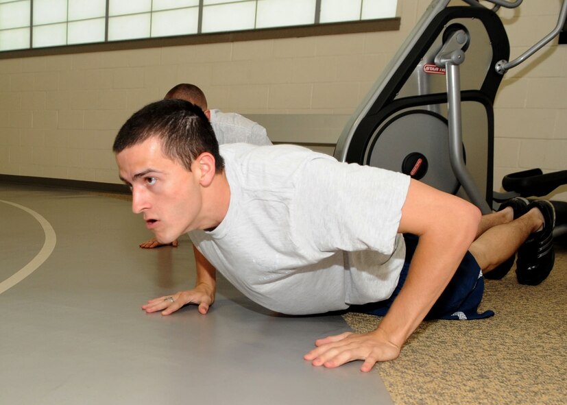 Airman 1st Class Drew Stockwell, 2nd Mission Operations Squadron, executes a push-up during a session of squadron physical fitness training on Barkdale Air Force Base, La., Jun 15. Good physical fitness is one of many standards airmen must maintain throughout their Air Force career. (U.S. Air Force photo/Senior Airman Kristin High)(RELEASED)