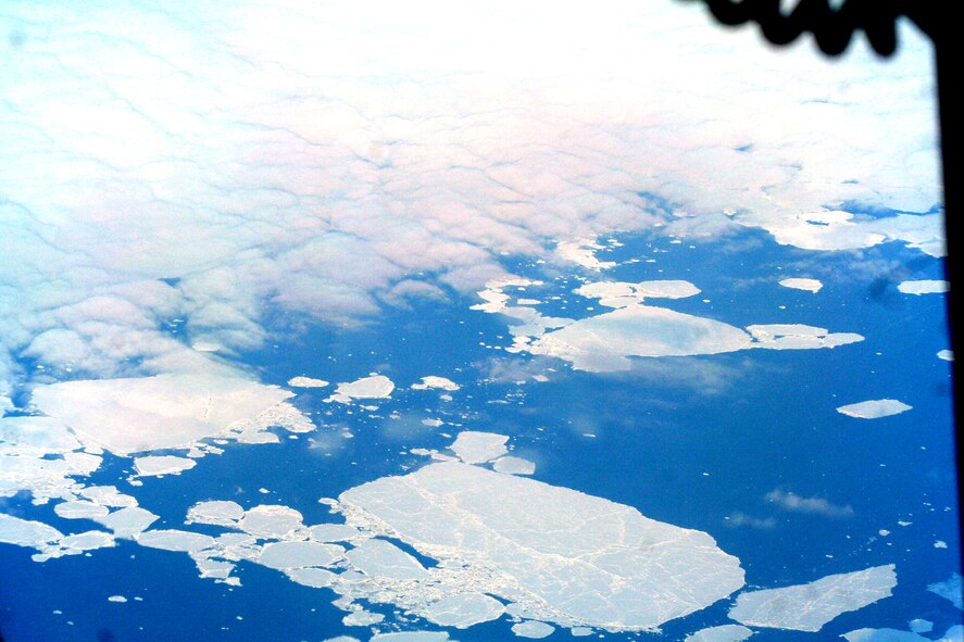 Ice-covered areas are seen from above the Arctic Circle from the window of a C-5M Super Galaxy on a  mission from Dover Air Force Base, Del., on June 5, 2011. The C-5M's mission was to complete the first Arctic overflight from Dover AFB to Bagram Airfield, Afghanistan. The plane successfully landed at Bagram just over 15 hours later on June 6, 2011. (U.S. Air Force Photo/Master Sgt. Scott T. Sturkol)