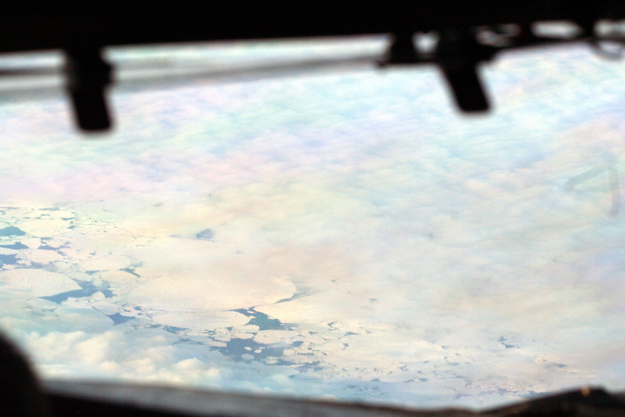 Ice-covered areas are seen from above the Arctic Circle from the window of a C-5M Super Galaxy on a  mission from Dover Air Force Base, Del., on June 5, 2011. The C-5M's mission was to complete the first Arctic overflight from Dover AFB to Bagram Airfield, Afghanistan. The plane successfully landed at Bagram just over 15 hours later on June 6, 2011. (U.S. Air Force Photo/Master Sgt. Scott T. Sturkol)