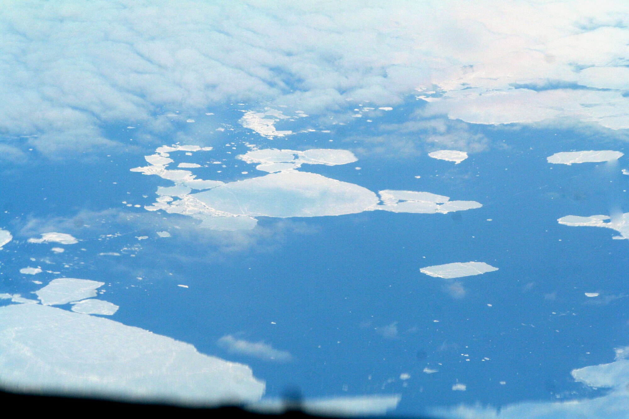 Ice-covered areas are seen from above the Arctic Circle from the window of a C-5M Super Galaxy on a  mission from Dover Air Force Base, Del., on June 5, 2011. The C-5M's mission was to complete the first Arctic overflight from Dover AFB to Bagram Airfield, Afghanistan. The plane successfully landed at Bagram just over 15 hours later on June 6, 2011. (U.S. Air Force Photo/Master Sgt. Scott T. Sturkol)