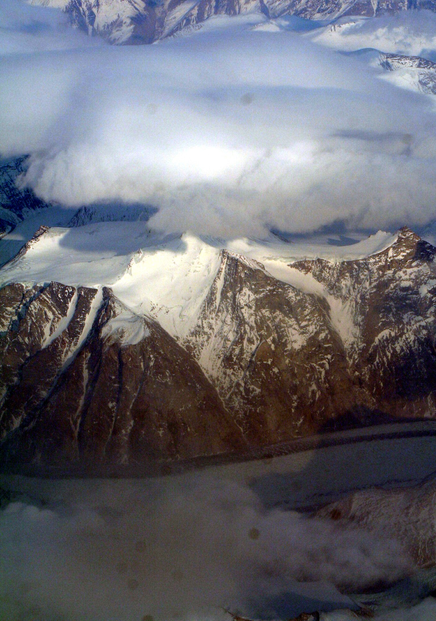 Ice-covered areas are seen from above the Arctic Circle from the window of a C-5M Super Galaxy on a  mission from Dover Air Force Base, Del., on June 5, 2011. The C-5M's mission was to complete the first Arctic overflight from Dover AFB to Bagram Airfield, Afghanistan. The plane successfully landed at Bagram just over 15 hours later on June 6, 2011. (U.S. Air Force Photo/Master Sgt. Scott T. Sturkol)