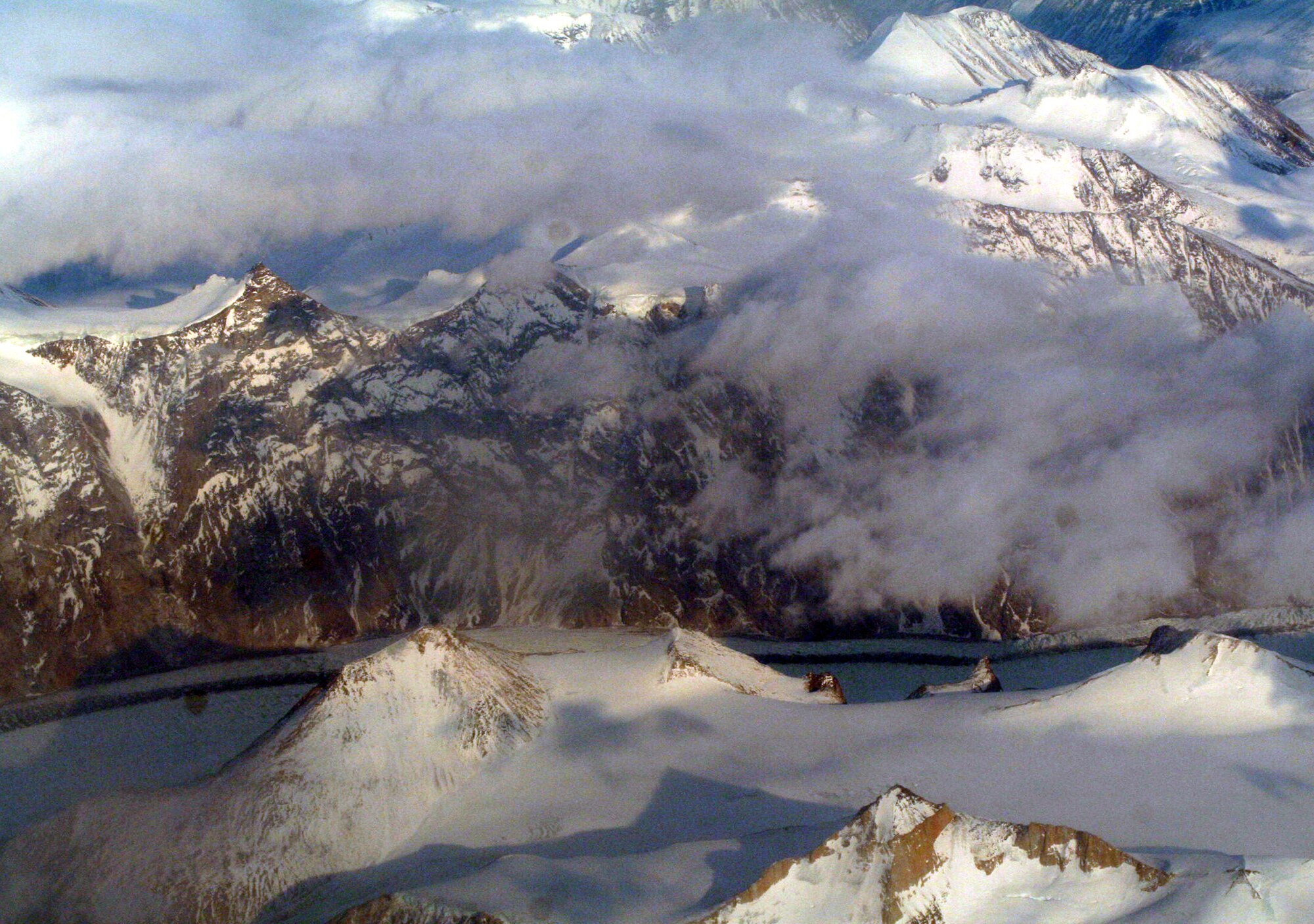 Ice-covered areas are seen from above the Arctic Circle from the window of a C-5M Super Galaxy on a  mission from Dover Air Force Base, Del., on June 5, 2011. The C-5M's mission was to complete the first Arctic overflight from Dover AFB to Bagram Airfield, Afghanistan. The plane successfully landed at Bagram just over 15 hours later on June 6, 2011. (U.S. Air Force Photo/Master Sgt. Scott T. Sturkol)