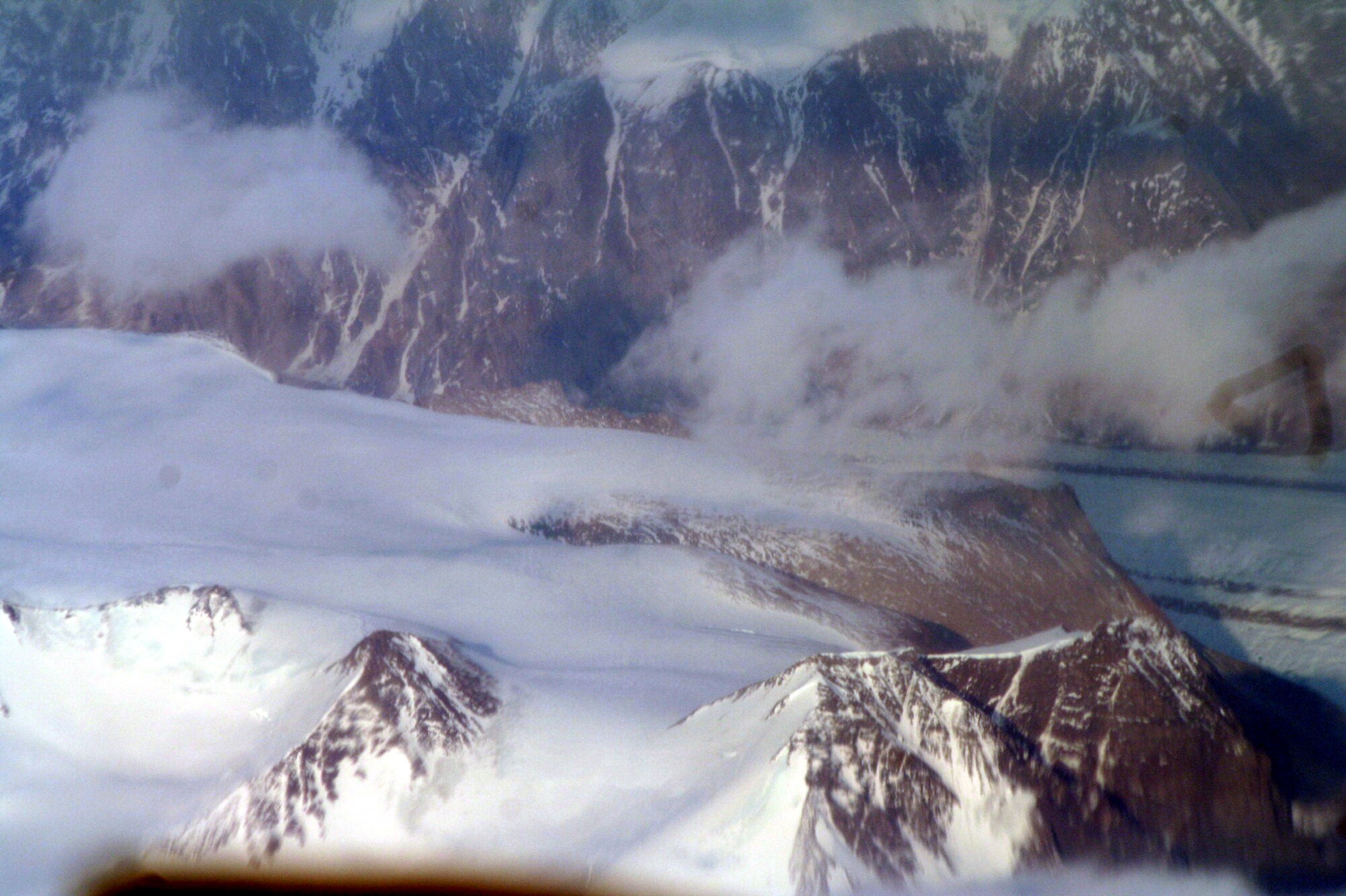 Ice-covered areas are seen from above the Arctic Circle from the window of a C-5M Super Galaxy on a  mission from Dover Air Force Base, Del., on June 5, 2011. The C-5M's mission was to complete the first Arctic overflight from Dover AFB to Bagram Airfield, Afghanistan. The plane successfully landed at Bagram just over 15 hours later on June 6, 2011. (U.S. Air Force Photo/Master Sgt. Scott T. Sturkol)
