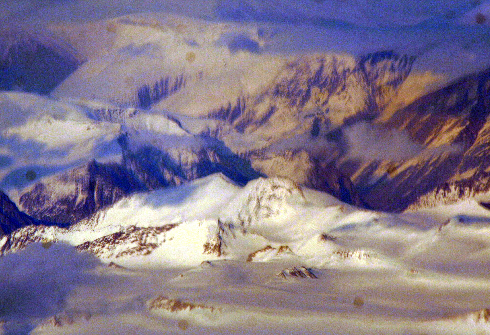 Ice-covered areas are seen from above the Arctic Circle from the window of a C-5M Super Galaxy on a  mission from Dover Air Force Base, Del., on June 5, 2011. The C-5M's mission was to complete the first Arctic overflight from Dover AFB to Bagram Airfield, Afghanistan. The plane successfully landed at Bagram just over 15 hours later on June 6, 2011. (U.S. Air Force Photo/Master Sgt. Scott T. Sturkol)