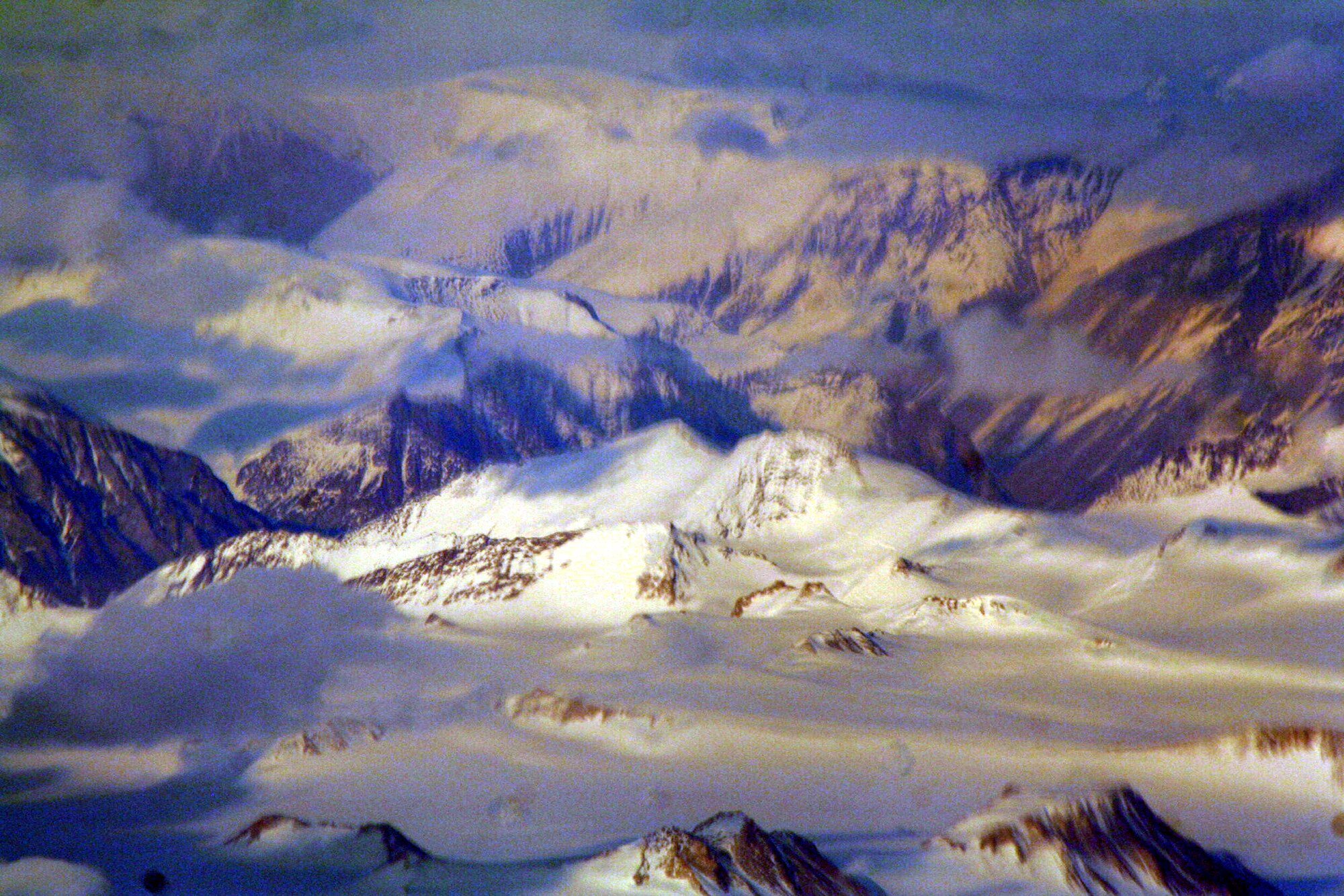Ice-covered areas are seen from above the Arctic Circle from the window of a C-5M Super Galaxy on a  mission from Dover Air Force Base, Del., on June 5, 2011. The C-5M's mission was to complete the first Arctic overflight from Dover AFB to Bagram Airfield, Afghanistan. The plane successfully landed at Bagram just over 15 hours later on June 6, 2011. (U.S. Air Force Photo/Master Sgt. Scott T. Sturkol)