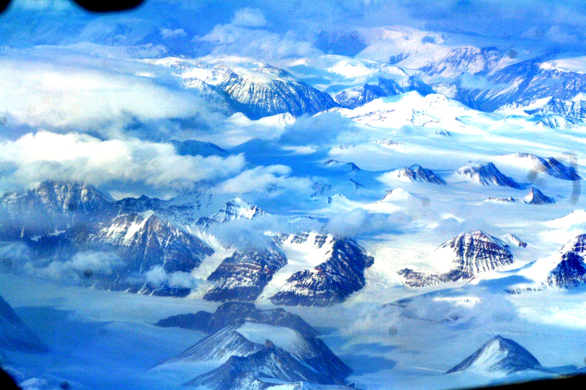 Ice-covered areas are seen from above the Arctic Circle from the window of a C-5M Super Galaxy on a  mission from Dover Air Force Base, Del., on June 5, 2011. The C-5M's mission was to complete the first Arctic overflight from Dover AFB to Bagram Airfield, Afghanistan. The plane successfully landed at Bagram just over 15 hours later on June 6, 2011. (U.S. Air Force Photo/Master Sgt. Scott T. Sturkol)