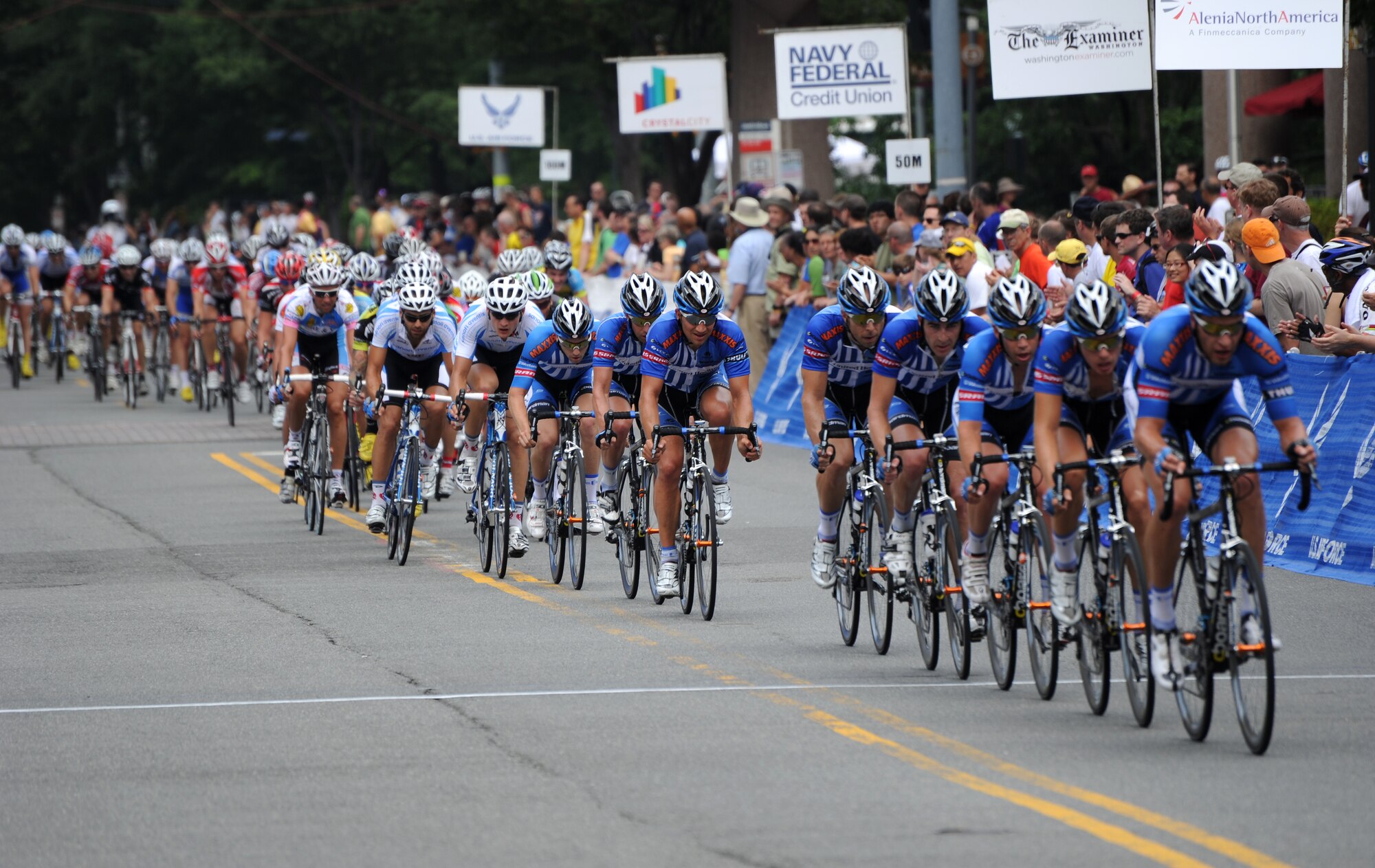 The eight-man United HealthCare cycling team dominate the Men’s Invitational Pro/Am race, June 12, 2011, Crystal City, Va., by teaming up to control the speed of the course on the final laps. The United HealthCare team went on to win the race taking first, second and third place. Jake Keough took first place followed by Hilton Clark in second and Robert Forster came in third. The afternoon race, in which 57 competitors raced at speeds greater than 25 miles per hour, was one of several races during the Air Force Cycling Classic held June 11-12. (U.S. Air Force photo by Master Sgt. Tracy L. DeMarco) (Released)