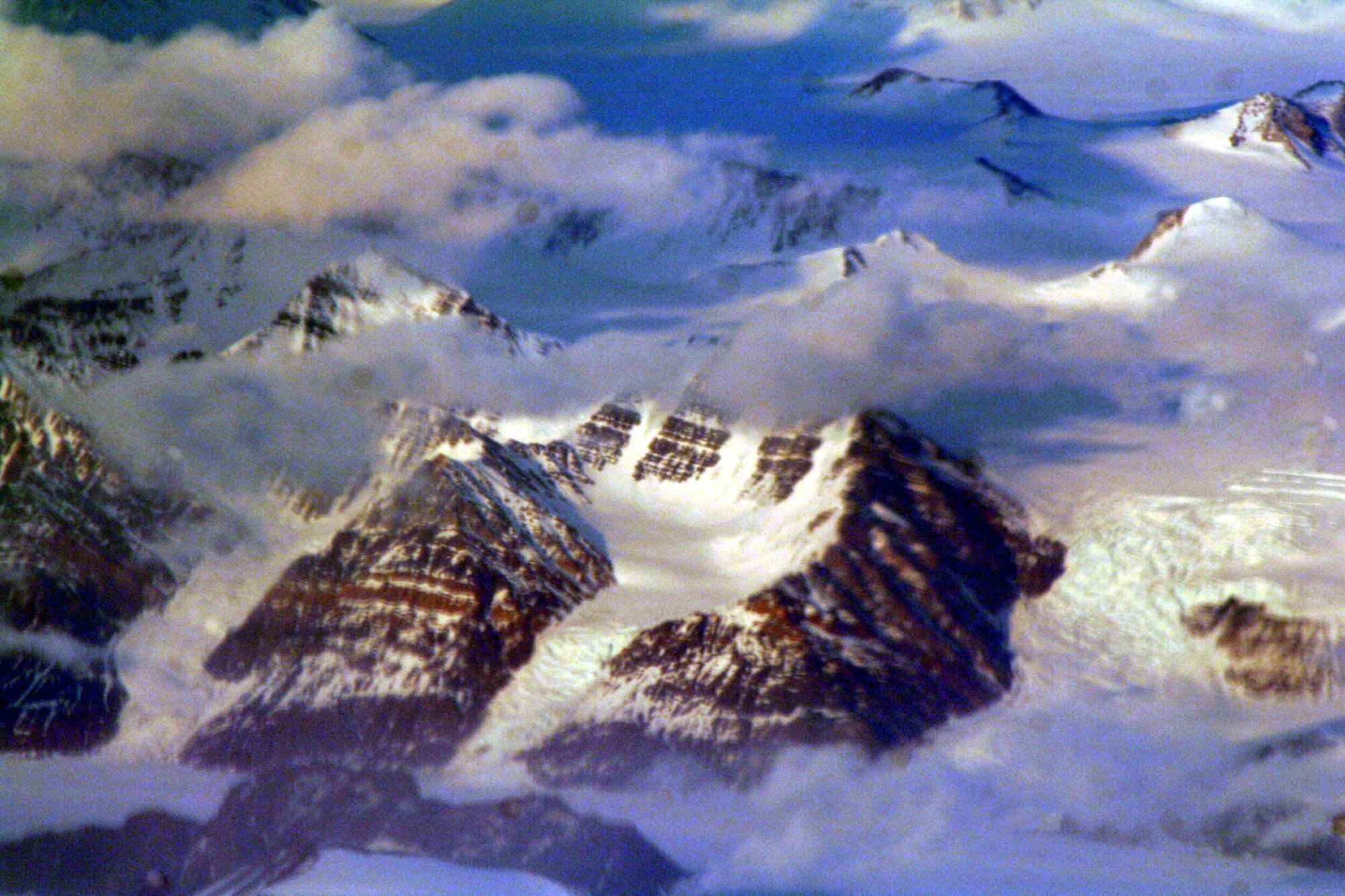 Ice-covered areas are seen from above the Arctic Circle from the window of a C-5M Super Galaxy on a  mission from Dover Air Force Base, Del., on June 5, 2011. The C-5M's mission was to complete the first Arctic overflight from Dover AFB to Bagram Airfield, Afghanistan. The plane successfully landed at Bagram just over 15 hours later on June 6, 2011. (U.S. Air Force Photo/Master Sgt. Scott T. Sturkol)