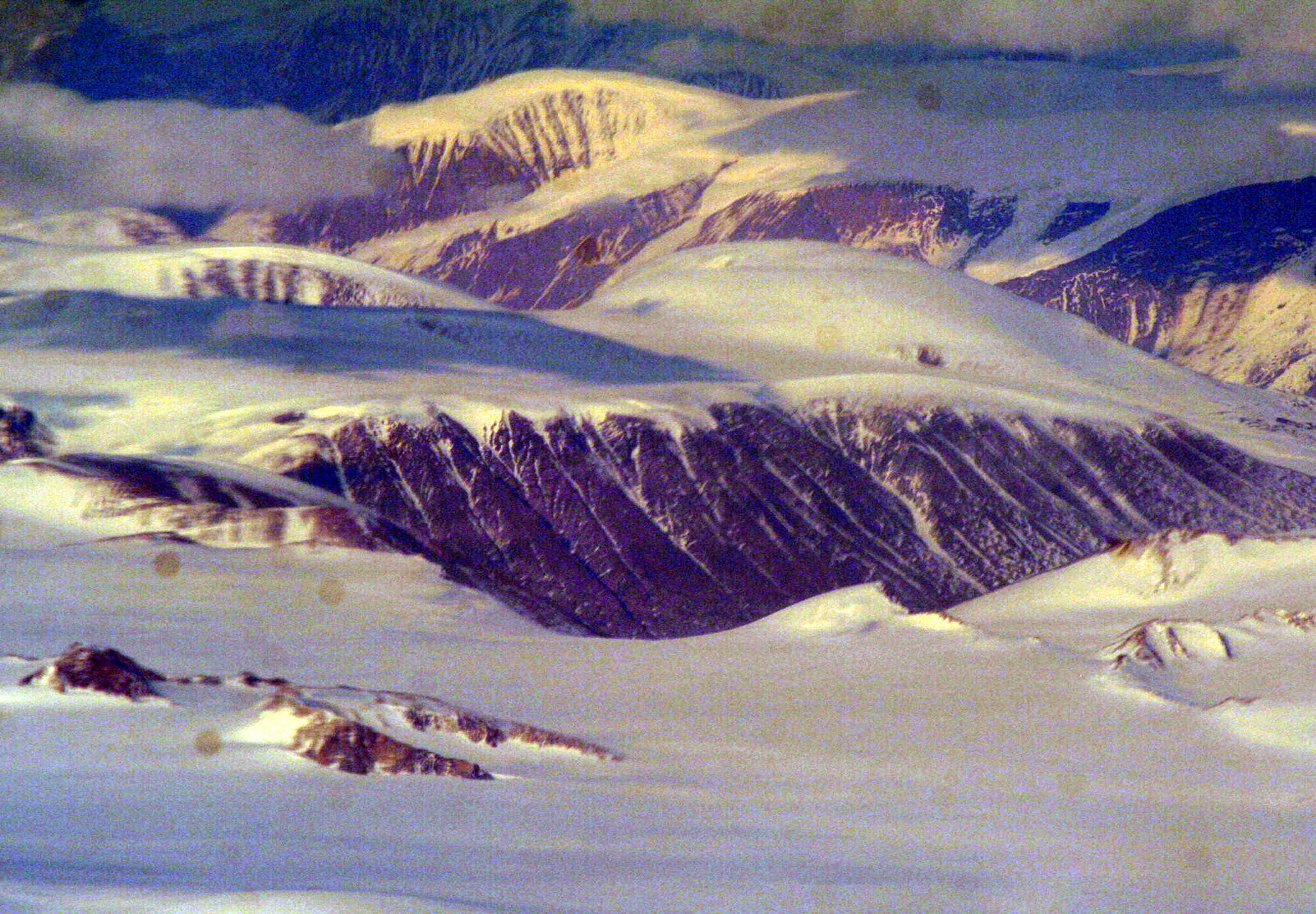 Ice-covered areas are seen from above the Arctic Circle from the window of a C-5M Super Galaxy on a  mission from Dover Air Force Base, Del., on June 5, 2011. The C-5M's mission was to complete the first Arctic overflight from Dover AFB to Bagram Airfield, Afghanistan. The plane successfully landed at Bagram just over 15 hours later on June 6, 2011. (U.S. Air Force Photo/Master Sgt. Scott T. Sturkol)
