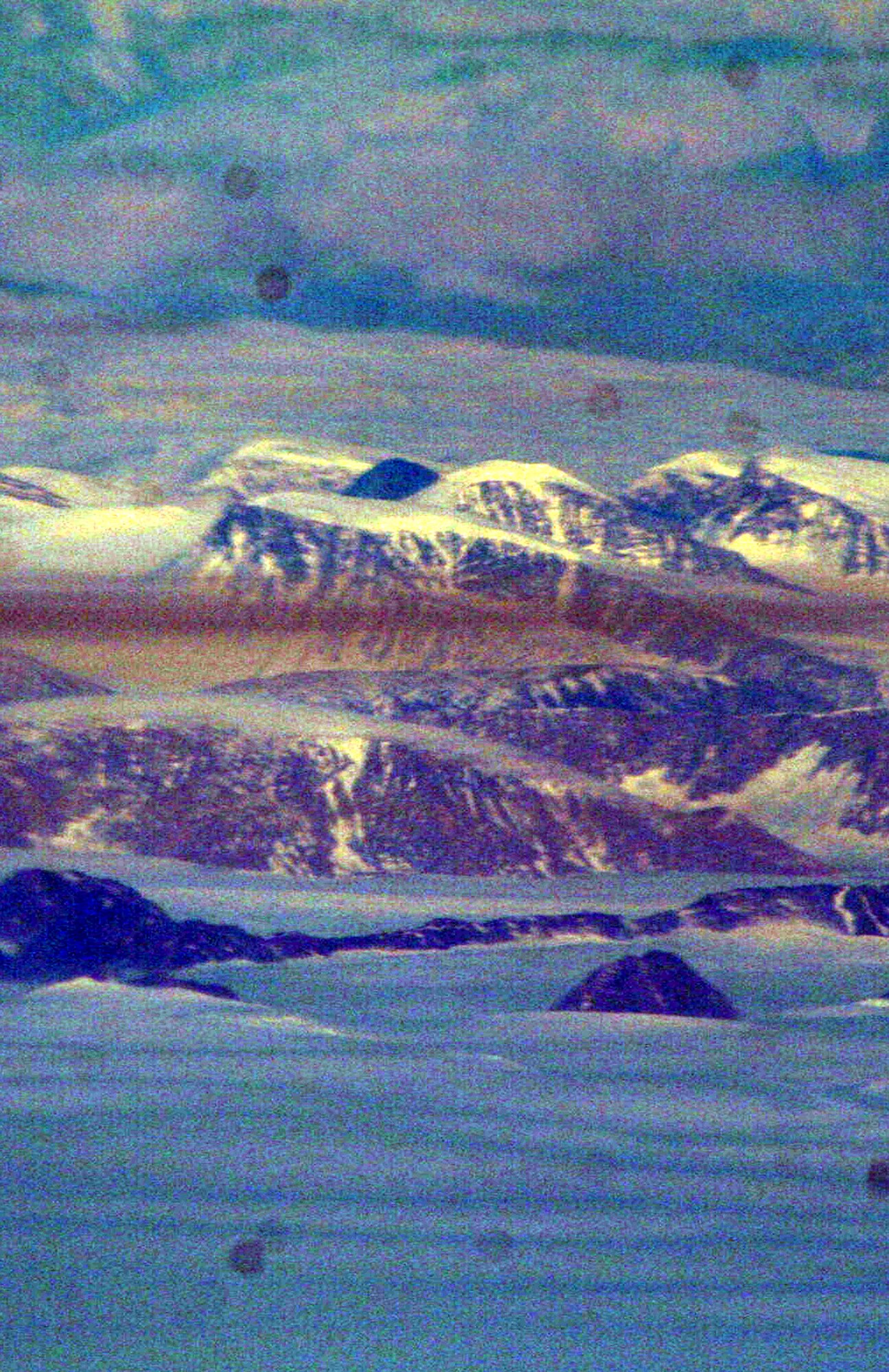 Ice-covered areas are seen from above the Arctic Circle from the window of a C-5M Super Galaxy on a  mission from Dover Air Force Base, Del., on June 5, 2011. The C-5M's mission was to complete the first Arctic overflight from Dover AFB to Bagram Airfield, Afghanistan. The plane successfully landed at Bagram just over 15 hours later on June 6, 2011. (U.S. Air Force Photo/Master Sgt. Scott T. Sturkol)