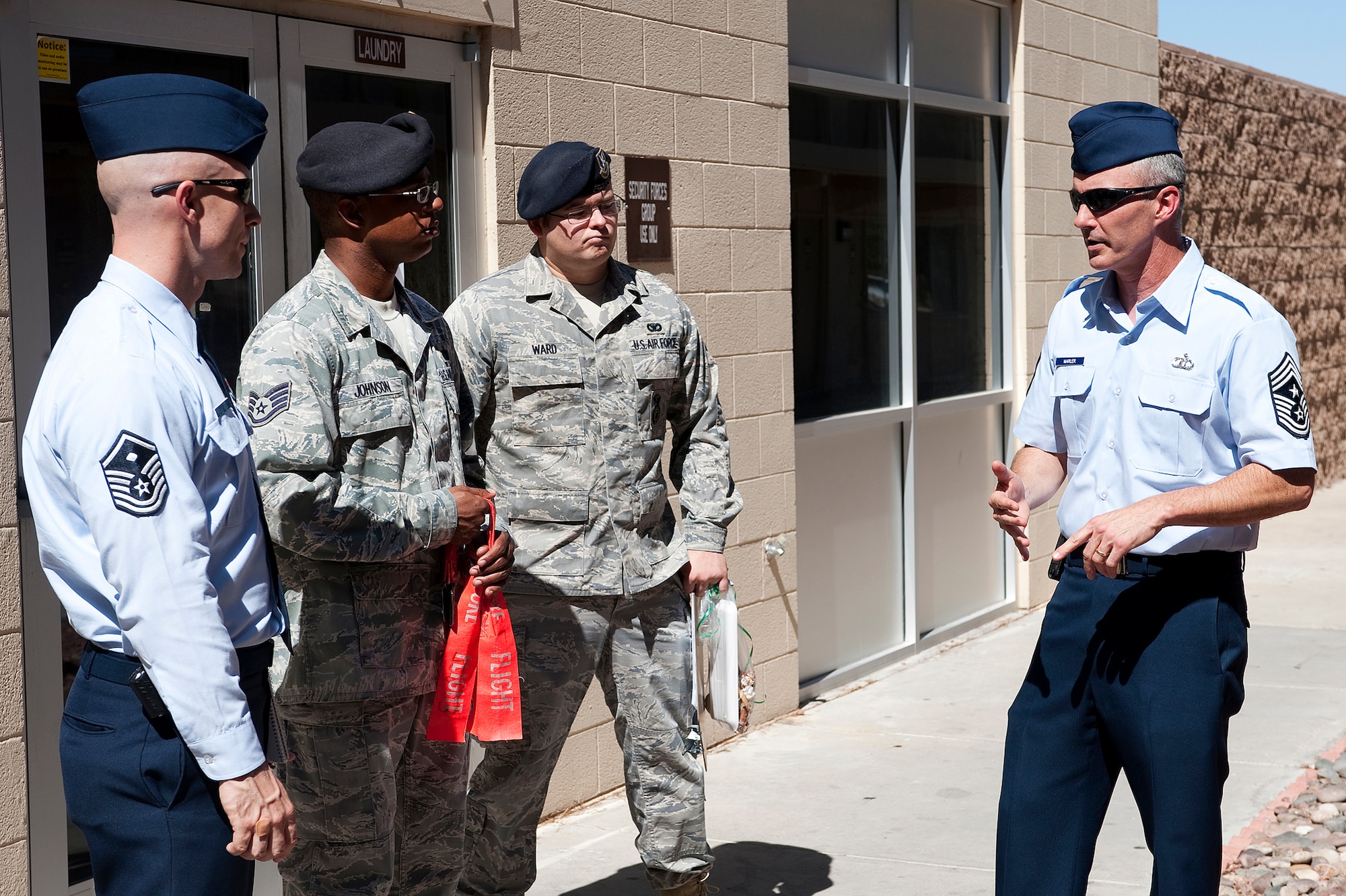 From right to left: Chief Master Sgt. Vincent L. Marler, command chief of the 99th Air Base Wing, discusses dormitory standard concerns with Senior Airman Scott Ward, assigned to the 99th Security Forces Squadron, Staff Sgt. Jewayne Johnson, a dormitory manager for the 99th Security Forces, and Master Sgt. Michael Macneil, 1st Sgt. of the 99th Security Forces Squadron, at the Nellis AFB dormitory on June 13, 2011.  Chief Marler inspects random dormitory facilities quarterly to ensure airmen's living standards are met.  (U.S. Air Force photo by Senior Airman Christopher Hubenthal/Released)
