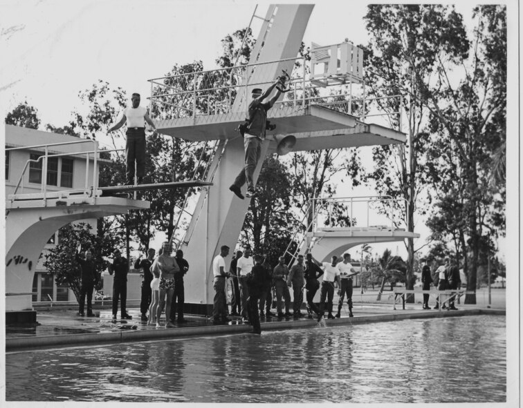 A trainee jumps off a diving board during water survival training at Schofield Barracks, Hawaii, in the mid 1960s. Retired Master Sgt. Bill Revell was one of the cadres from the 1041st Security Police Squadron (test) who trained Airmen in tasks like water survival. (Courtesy photo)
