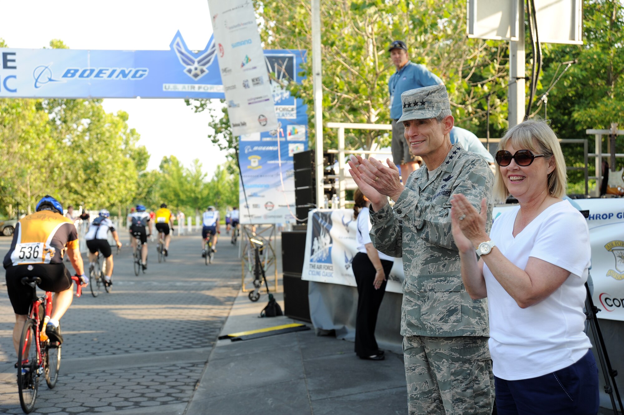 Air Force Chief of Staff Gen. Norton Schwartz and his wife Suzie cheer from the sidelines of the Air Force Cycling Classic’s Crystal Ride course near the Air Force Memorial in Arlington, Va., June 12, 2011. More than 1,600 registrants rode as separate competitors or in teams to raise money.  One of those teams, Team Sabre, raised $20,000 on June 12, 2011, which was donated to the Air Force Aid Society to help Airmen and their families. (U.S. Air Force photo by Master Sgt. Tracy L. DeMarco) (Released)