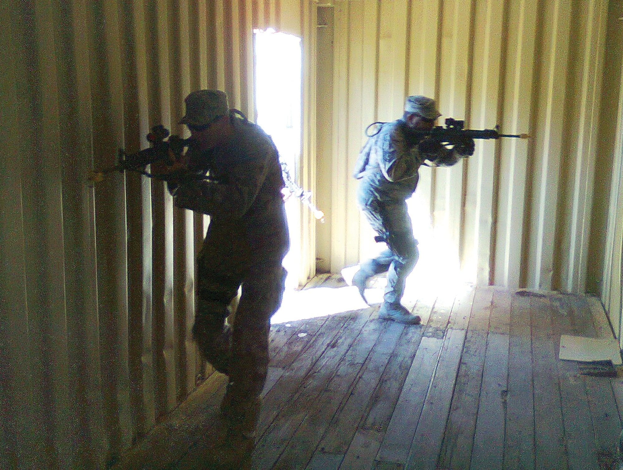 Airman Brian Tice and Tech. Sgt. Steven Higginbotham practice room clearing during the urban operations phase of Patriot Defender training.