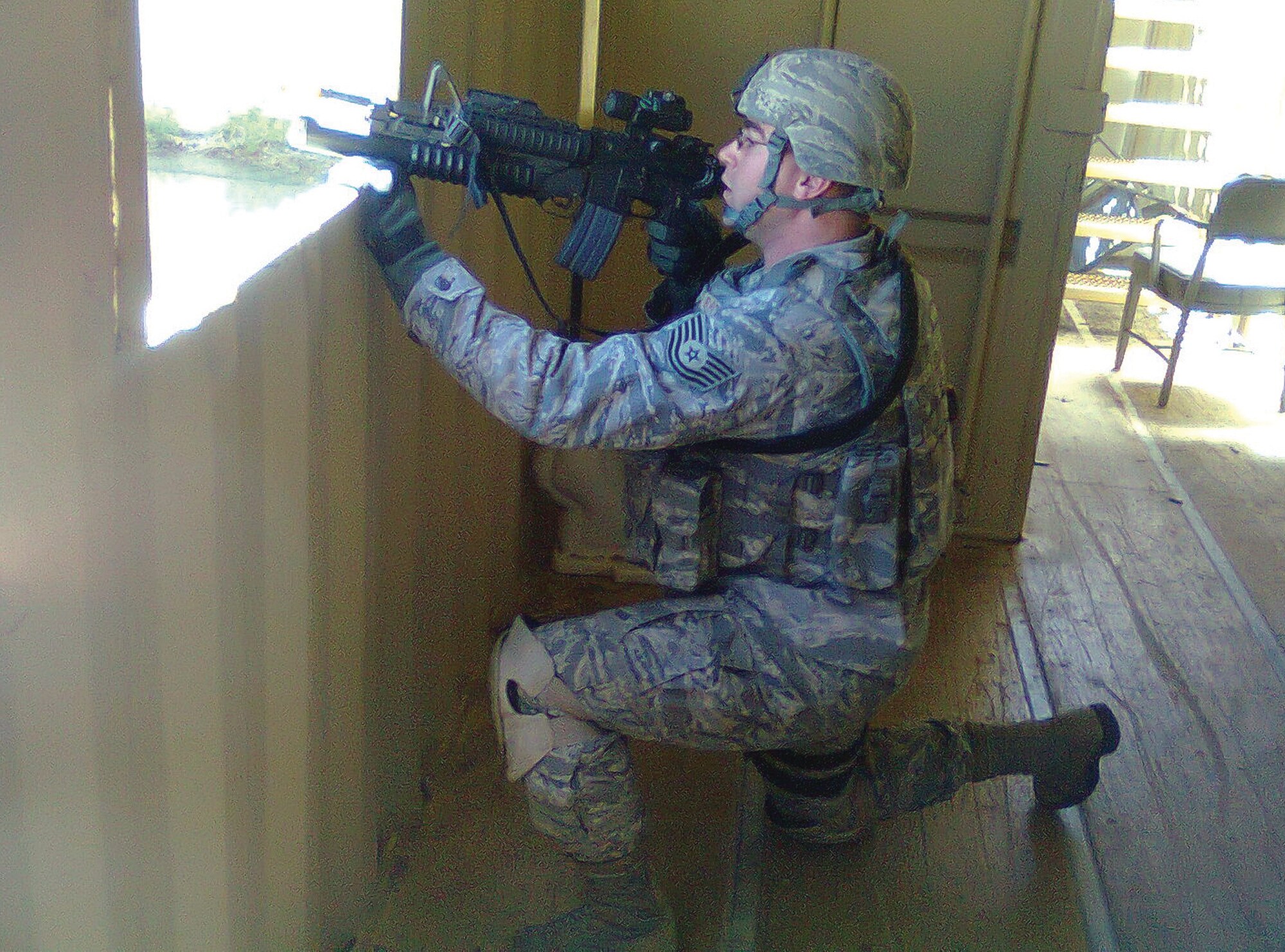 Tech. Sgt Matthew Johnson, a member of the 908th SFS, covers a window during Patriot Defender urban combat operations training in Texas.