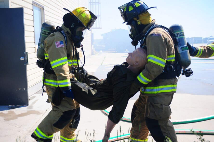 Two Soldiers from the Washington State Army National Guard, pull a body out of a simulated burning structure as part of the 2011 Golden Coyote exercise on Ellsworth Air Force Base, S.D., June 15, 2011. Units from 17 different states and three foreign countries are participating in the exercise, which allowed them to focus on unit training and aiding Native Americans with critical medical and infrastructure support. (U.S. Air Force photo/Amn Alystria Maurer/Released)
