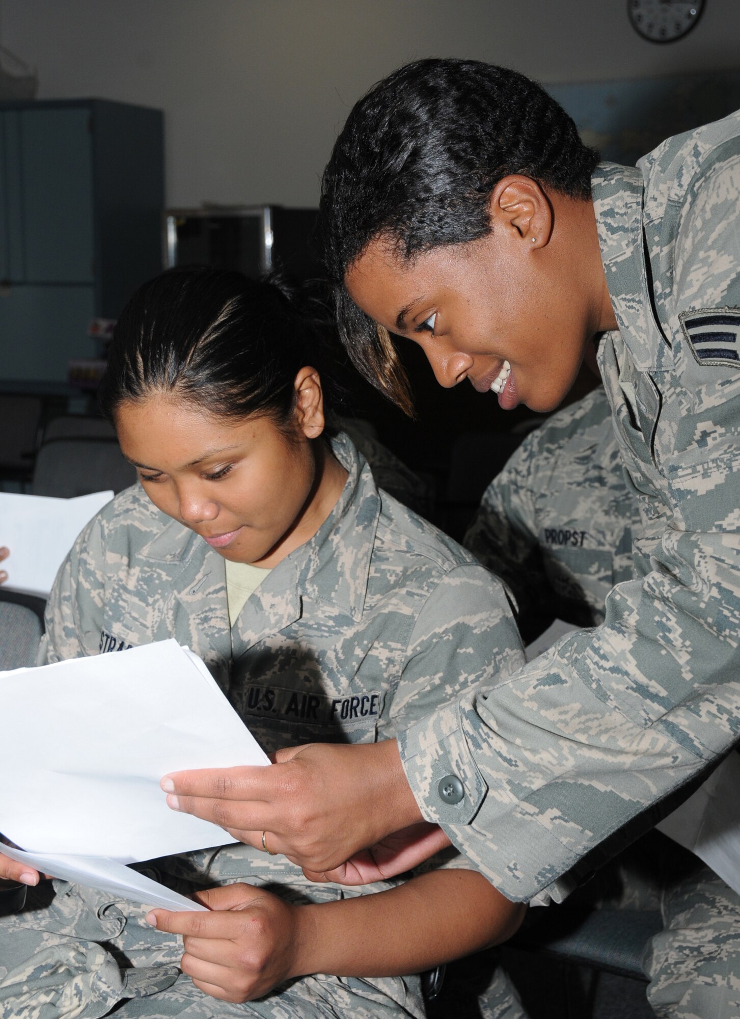 Airman Basic Jacklyn Estrada, left, a student in the 335th Training Squadron, is briefed by Senior Airman Katrina Mitchell April 7 at the student personnel center in the Levitow Training Support Facility.  (U.S. Air Force photo by Kemberly Groue)