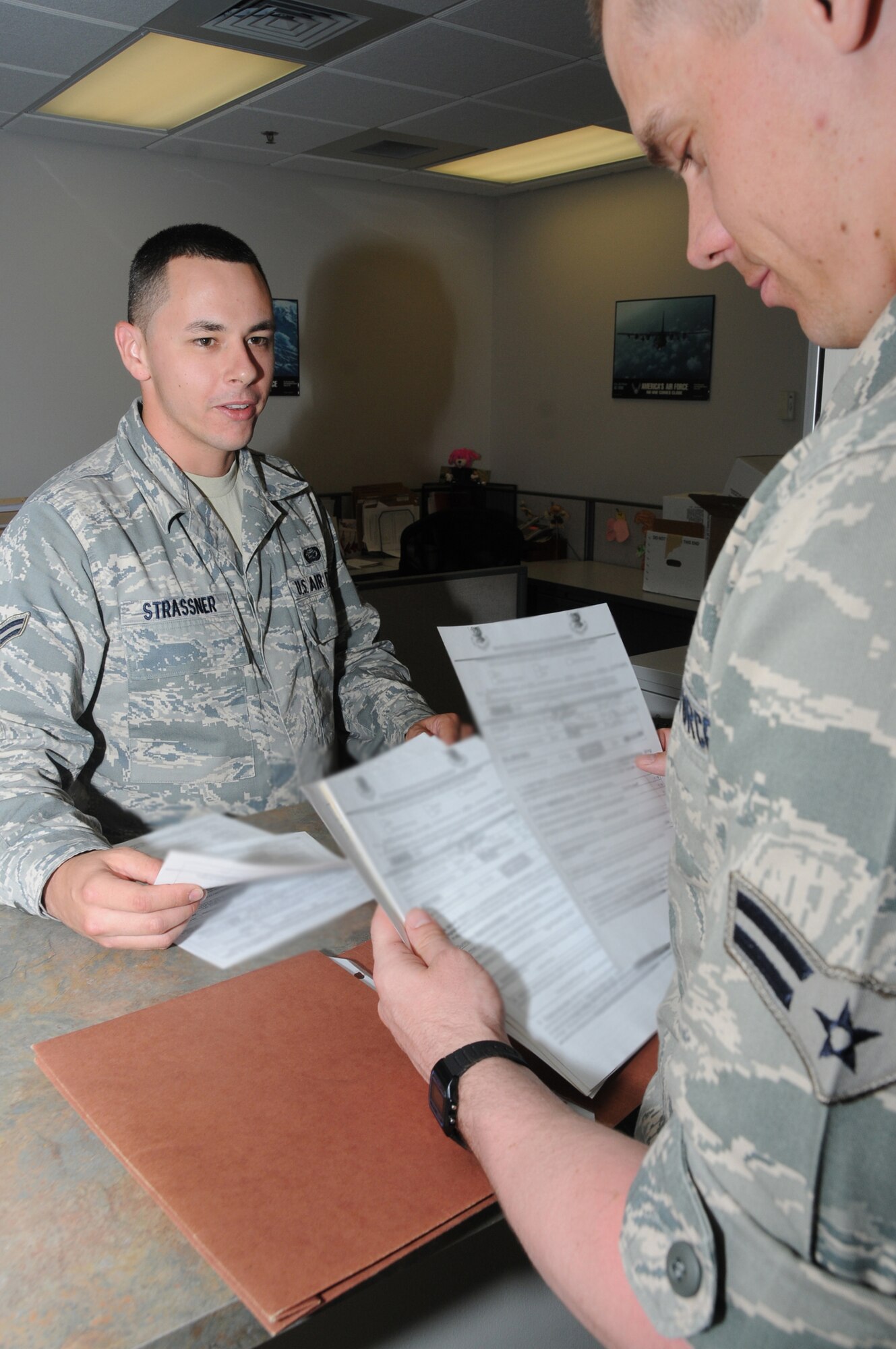 Airman 1st Class Jason Strassner, 81st FSS, assists Airman 1st Class Michael Cooper with his outprocessing April 7 at the student personnel center in the Levitow Training Support Facility.  (U.S. Air Force photo by Kemberly Groue)