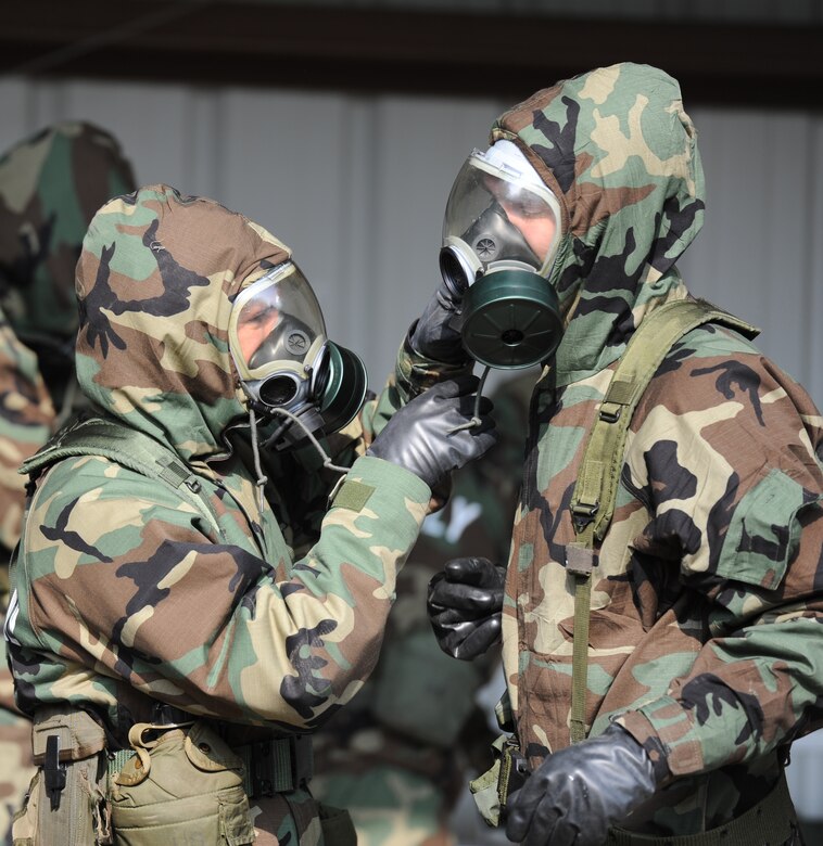 Senior Master Sgt. Kevin Kloeppel helps Tech. Sgt. Gregory Ford close the hood on his chemical suit during Chemical Biological Radiological Nuclear and high yield Explosive Training on Joint Base Charleston, June 9. The CBRNE course teaches Airmen how to survive and operate in hazardous environments.  Sergeant Kloeppel is the 15 Airlift Squadron Superintendent and Sergeant Ford is a tactics loadmaster with the 437th Operations Support Squadron.  (U.S. Air Force photo/ Staff Sgt. Nicole Mickle)