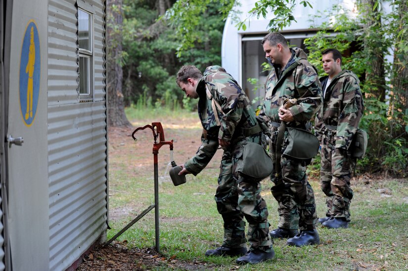 Airmen fill their canteens with water during a break in Chemical Biological Radiological Nuclear and high yield Explosive Training on Joint Base Charleston, June 9. The CBRNE course teaches Airmen how to survive and operate in hazardous environments. (U.S. Air Force photo/ Staff Sgt. Nicole Mickle)