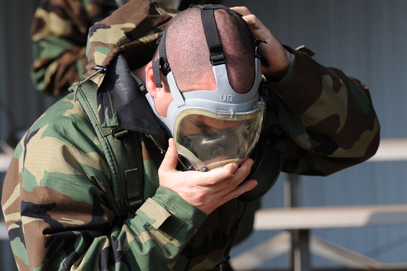 Senior Master Sgt. Kevin Kloeppel dons his gas mask during Chemical Biological Radiological Nuclear and high yield Explosive Training at Joint Base Charleston,  June 9. Sergeant Kloeppel is the 15 Airlift Squadron superintendent. (U.S. Air Force photo/ Staff Sgt. Nicole Mickle)
