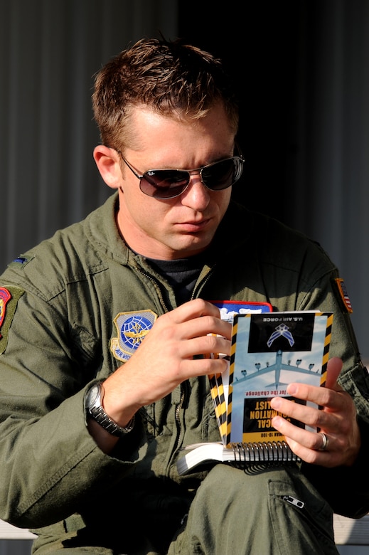 1st. Lt. Austin McCann looks through his Airman's manual during Chemical Biological Radiologial Nuclear and high yield Explosive Training June 9, at Joint Base Charleston.  The CBRNE course teaches Airmen how to survive and operate in hazardous environments whether deployed or at home station. Lieutenant McCann is assigned to the 15th Airlift Squadron. (U.S. Air Force photo/ Staff Sgt. Nicole Mickle)  