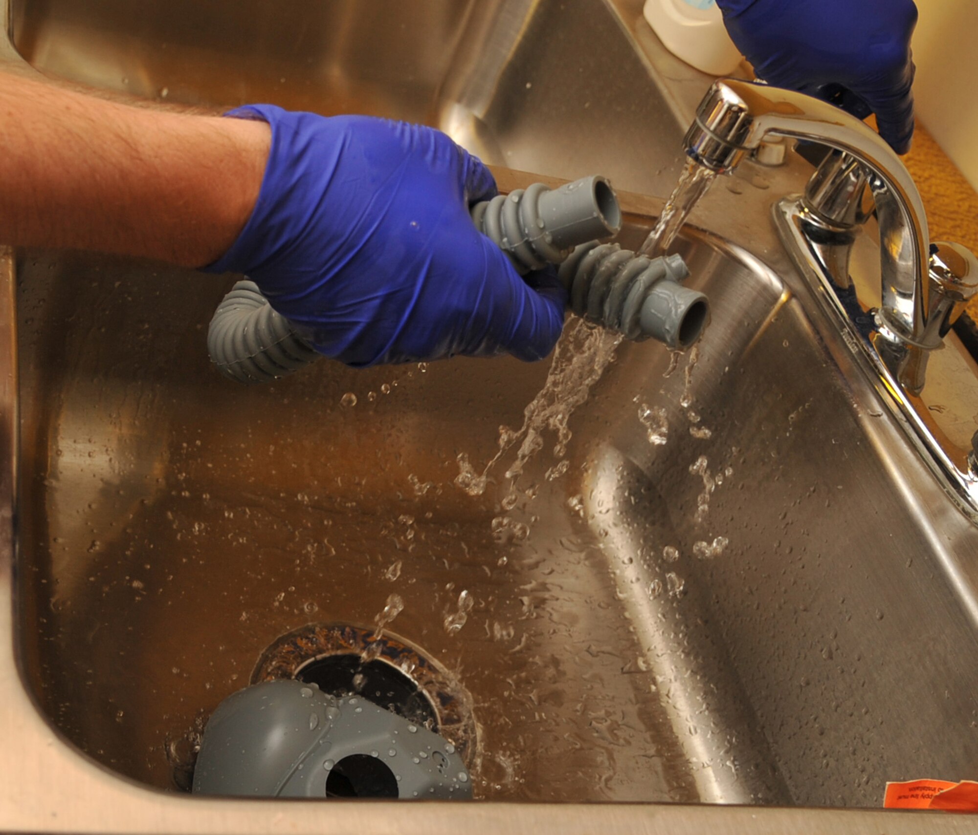 SEYMOUR JONHSON AIR FORCE BASE, N.C.- Staff Sgt. Eric Pancia rinses an oxygen hose during an inspection here, June 14, 2011. All aircrew members' equipment receives an inspection every 30 days. Cleaning out debris and bacteria in the mask and oxygen hose adds to the longevity of the items. Sergeant Pancia is a 4th Operations Support Squadron aircrew flight equipment craftsman and a native of Buffalo, N.Y. (U.S. Air Force photo by Senior Airman Whitney Lambert/RELEASED)