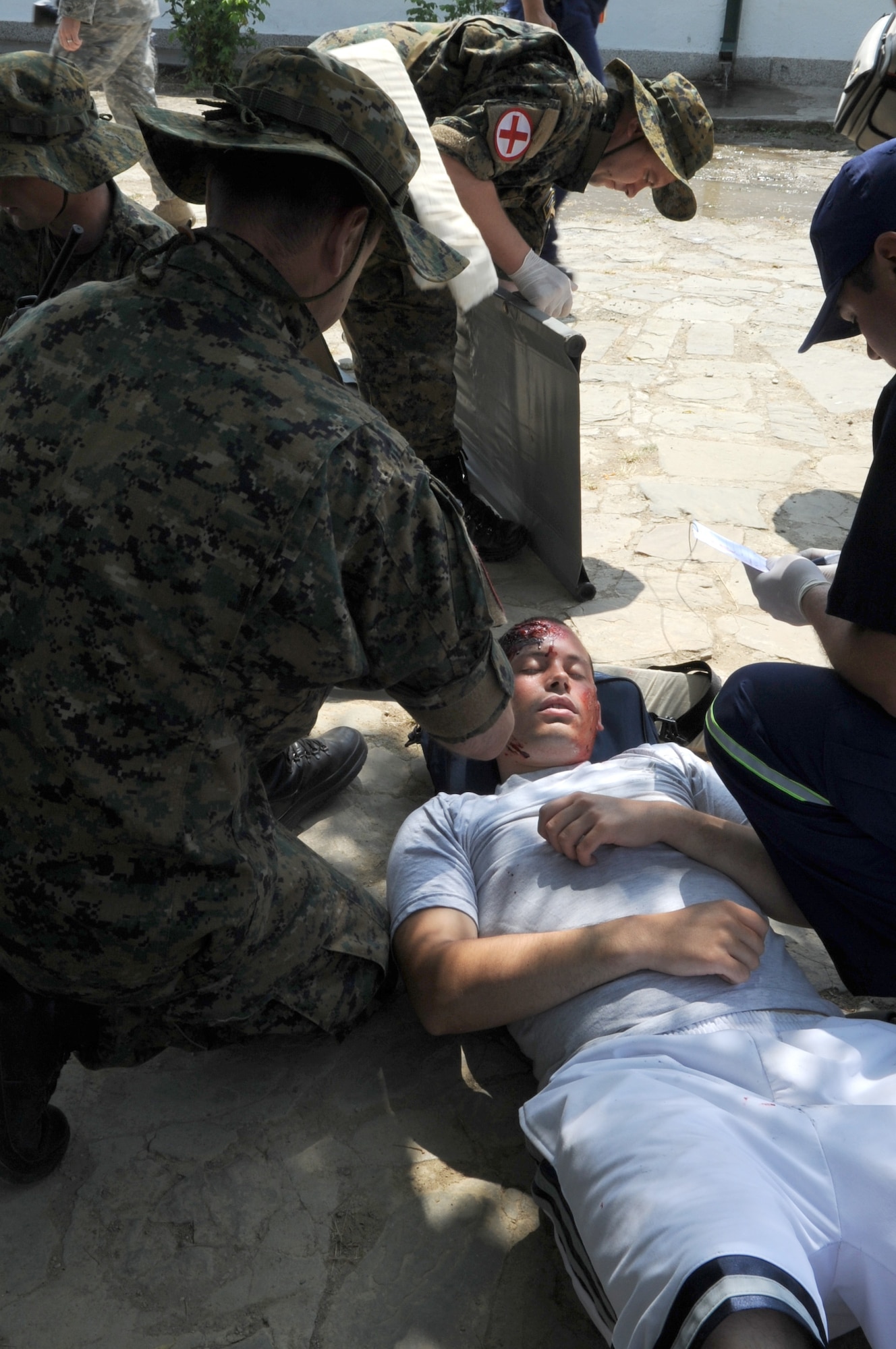 CAMP PEPELISHTE, Macedonia -- Macedonian medical personnel participating in the 2011 Medical Training Exercise in Central and Eastern Europe, provide medical assistance to victims of a simulated building fire during the MEDCEUR 11 distinguished visitors day June 13. An annual Chairman of the Joint Chiefs of Staff-sponsored regional and multilateral exercise, MEDCEUR is designed to provide medical training and operational experience in a deployed environment for U.S. and partner nations. The countries participating in this year's MEDCEUR are Macedonia, Montenegro, Bosnia and Herzegovina, Serbia, Slovenia and Norway. (U.S. Air Force photo/Staff Sgt. Nadine Y. Barclay)