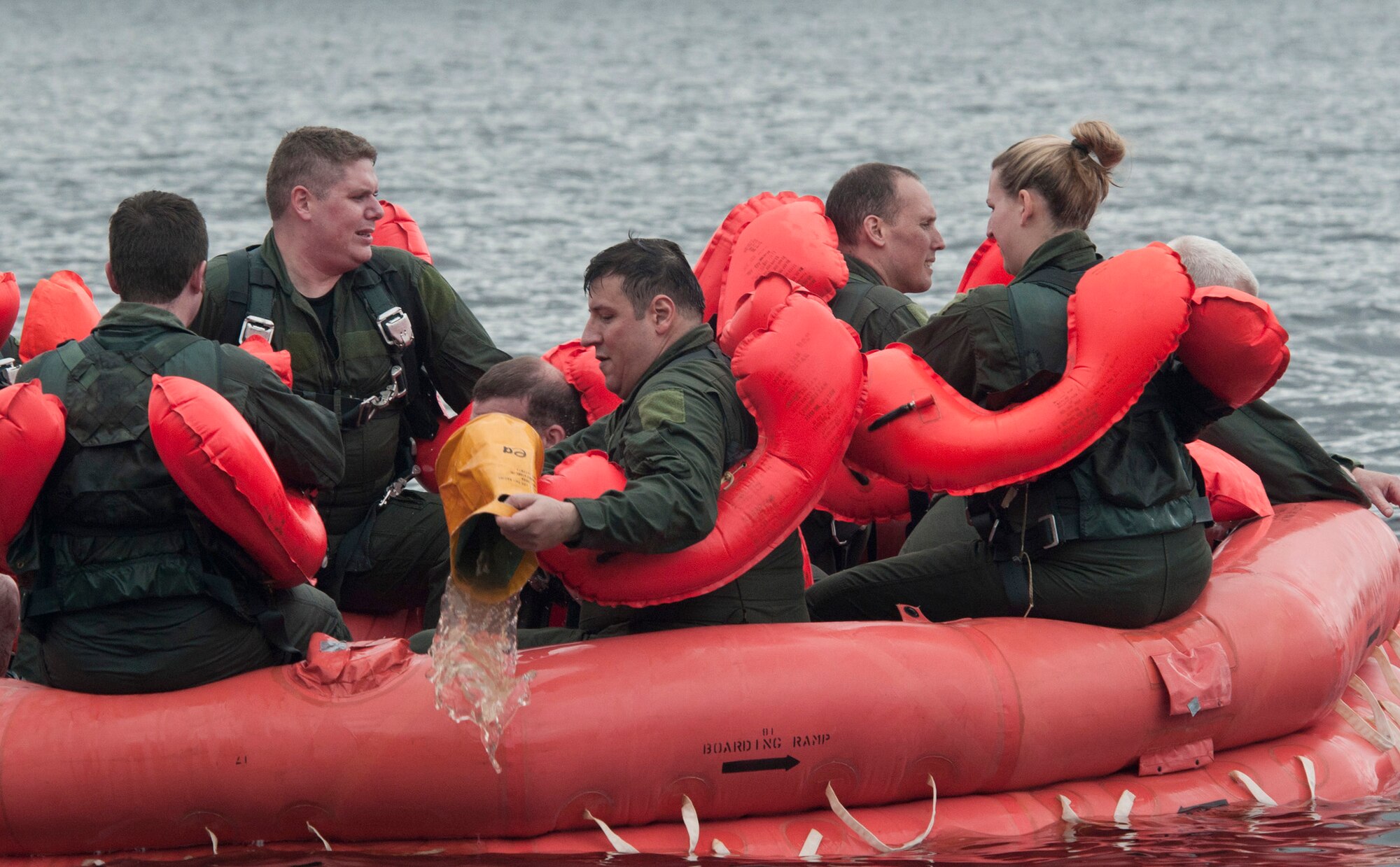 Airmen remove water from a 20-person life raft June 11, 2011, during aircrew survival training in the St. Croix River near Hastings, Minn. (U.S. Air Force photo/Tech. Sgt. Erik Gudmundson)