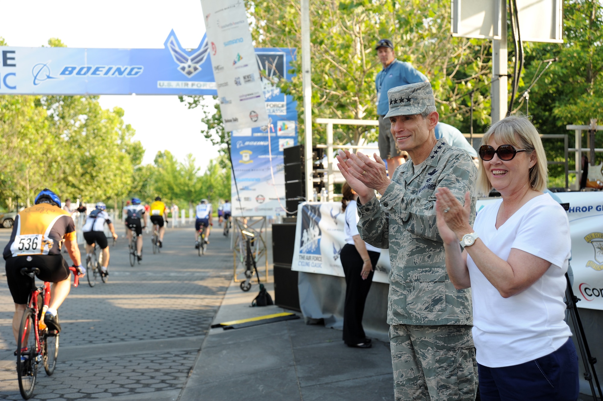 Air Force Chief of Staff Gen. Norton Schwartz and his wife Suzie cheer from the sidelines near the Air Force Memorial in Arlington, Va., June 12, 2011, during the Air Force Cycling Classic’s Crystal Ride event. More than 1,600 registrants rode as separate competitors or in teams to raise money.  One of those teams, Team Sabre, raised $20,000 which they donated to the Air Force Aid Society to help Airmen and their families. (U.S. Air Force photo/Master Sgt. Tracy L. DeMarco)