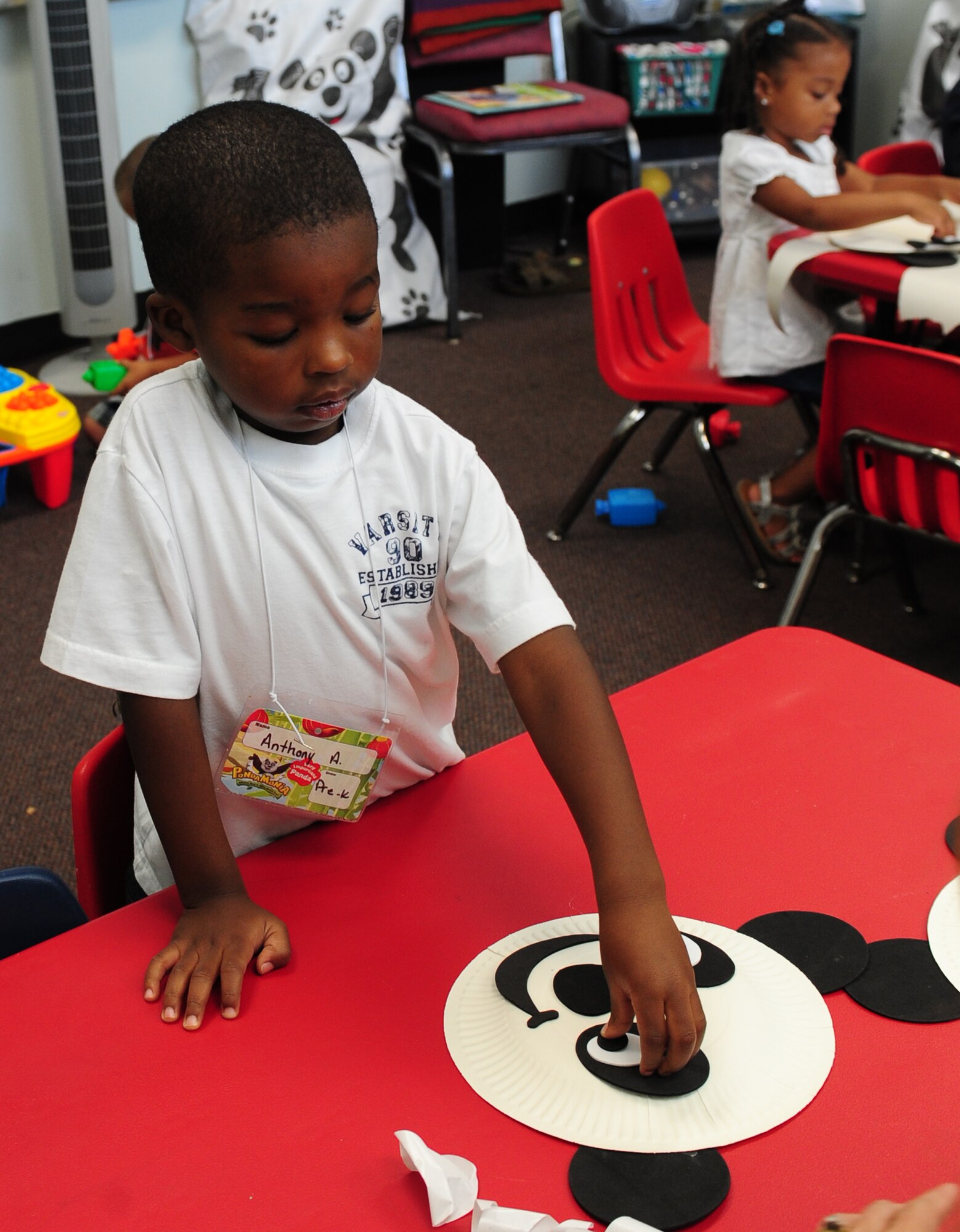 Anthony Anderson uses black and white foam cutouts and a paper plate to make a panda bear for his mom and dad during Pandamania Vacation Bible School held at Moody Air Force Base, Ga., June 14, 2011. The purpose of VBS is to teach basic biblical principals into the lives of military children and to provide a safe nurturing place for children to learn through play, fellowship and song. (U.S. Air Force Senior Airman Stephanie Mancha/Released)