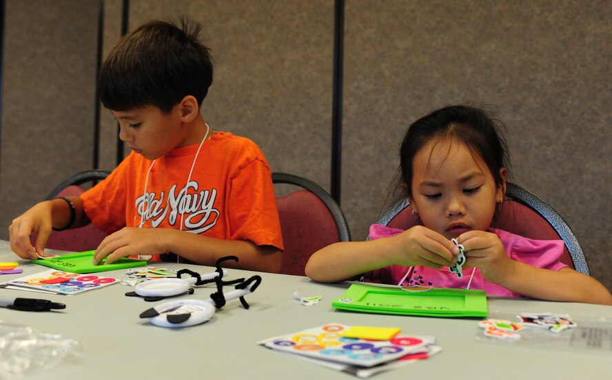 Brother and sister Justin and Tiffany Thorson, dependants of U.S. Air Force Master Sgt. Erin Thorson, 347th Rescue Group, decorate a foam picture frame  in the chapel’s arts and crafts room during Pandamania Vacation Bible School at Moody Air Force Base, Ga., June 14, 2011. Approximately 90 children enrolled in this year’s vacation bible school from preschool through 5th grade. (U.S. Air Force Senior Airman Stephanie Mancha/Released)