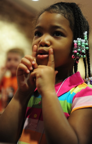 Malkia Williams, daughter of U.S. Navy Petty Officer Second Class James Williams, sings and dances to one of the many songs learned during Pandamania Vacation Bible School at Moody Air Force Base, Ga., June 14, 2011. The children were taught different choreographed songs about love to help them understand how to become better people. (U.S. Air Force Senior Airman Stephanie Mancha/Released)
