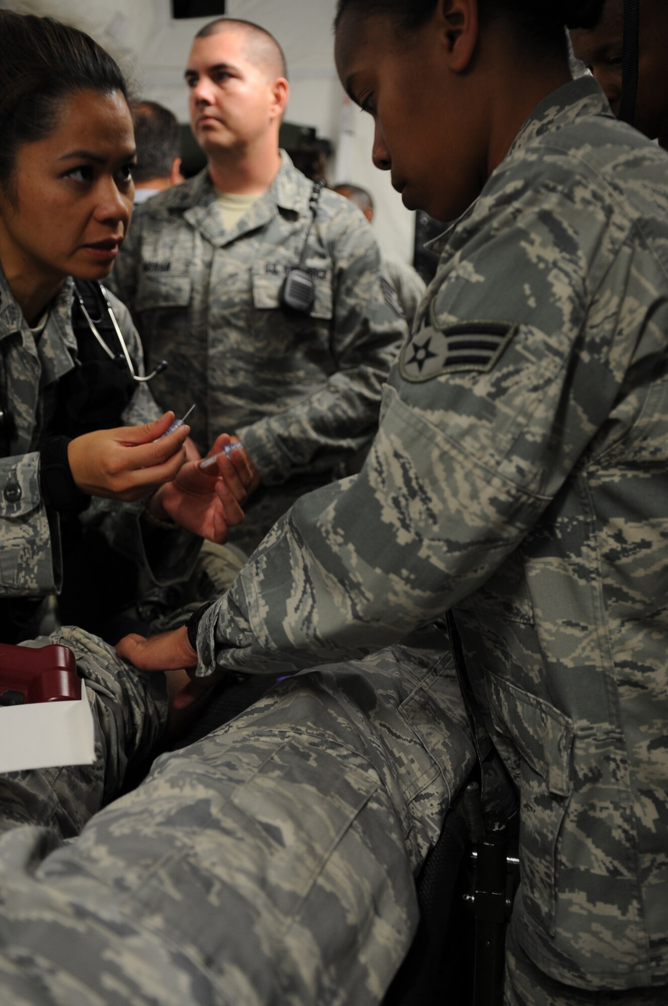CAMP PEPELISHTE, Macedonia ? Senior Airman Krystal Champ, 31st Medical Group medical technician from Aviano Air Base, Italy, prepares to administer fluids through the bone to a patient before a simulated emergency surgery during the 2011 Medical Training Exercise in Central and Eastern Europe June 13. An annual Chairman of the Joint Chiefs of Staff-sponsored regional and multilateral exercise, MEDCEUR is designed to provide medical training and operational experience in a deployed environment for U.S. and partner nations. The countries participating in this year's MEDCEUR are Macedonia, Montenegro, Bosnia and Herzegovina, Serbia, Slovenia and Norway. (U.S. Air Force photo/Staff Sgt. Nadine Y. Barclay)